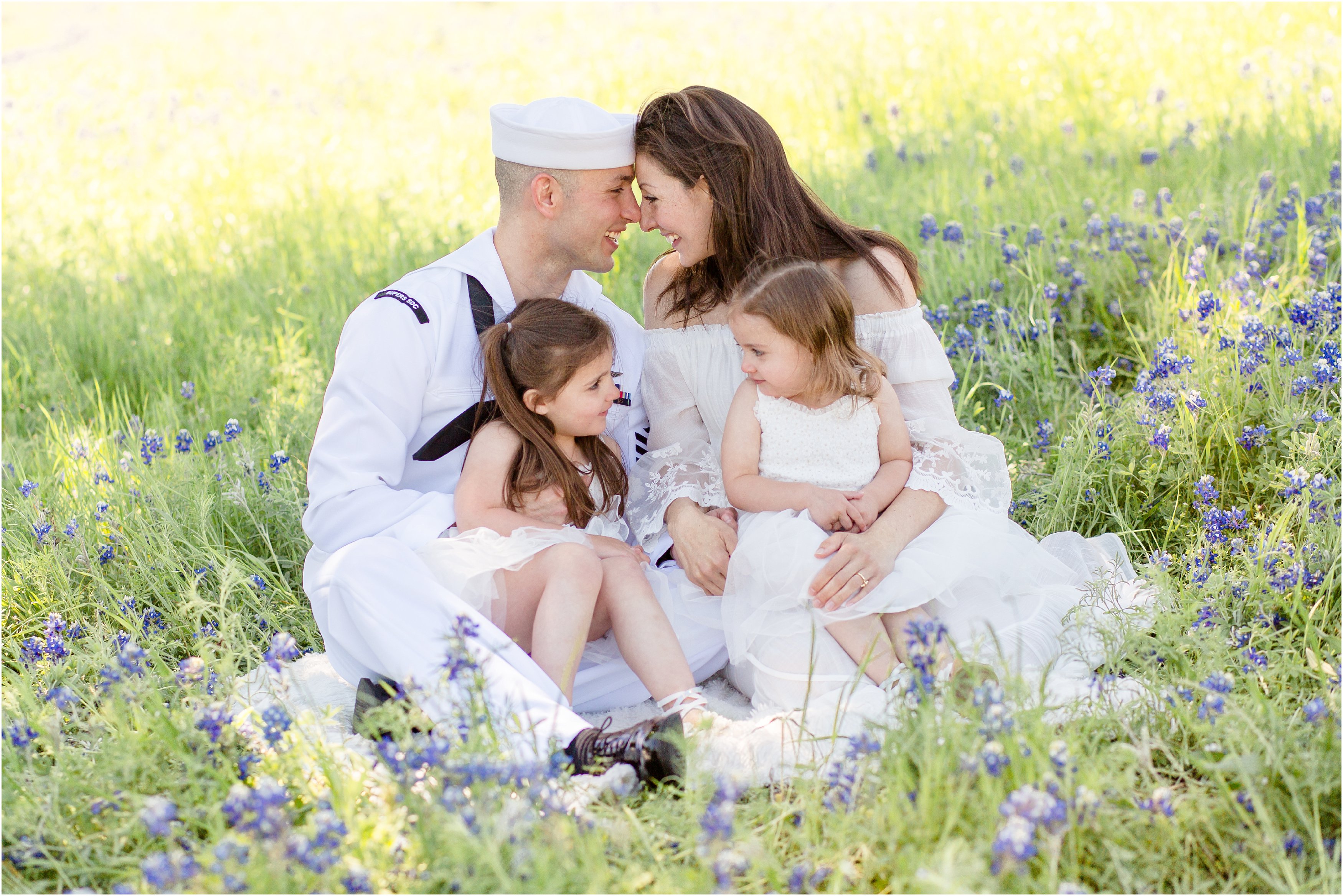 military family in a bluebonnet field