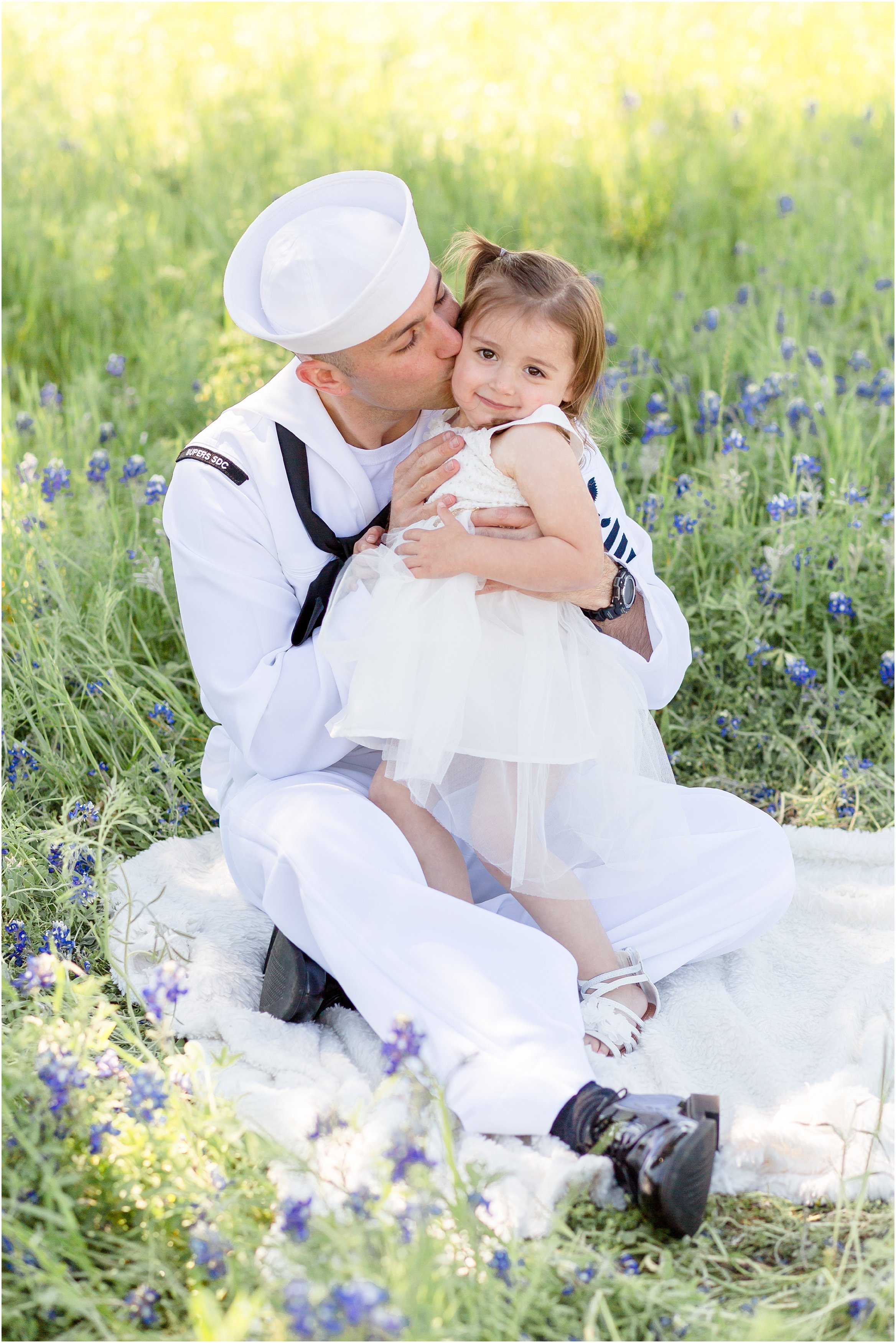 military dad with daughter in a bluebonnet field