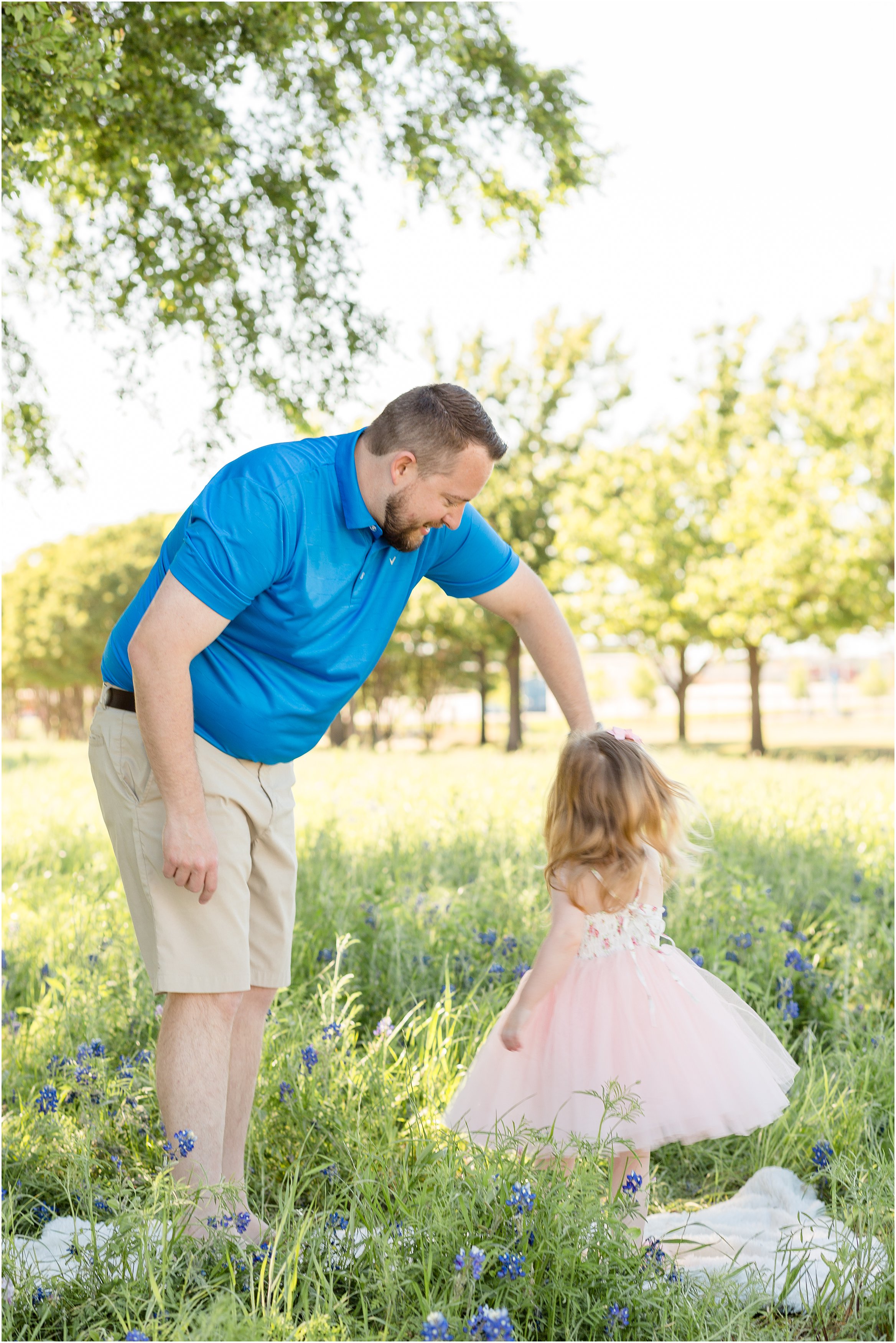 daddy daughter dancing in a field