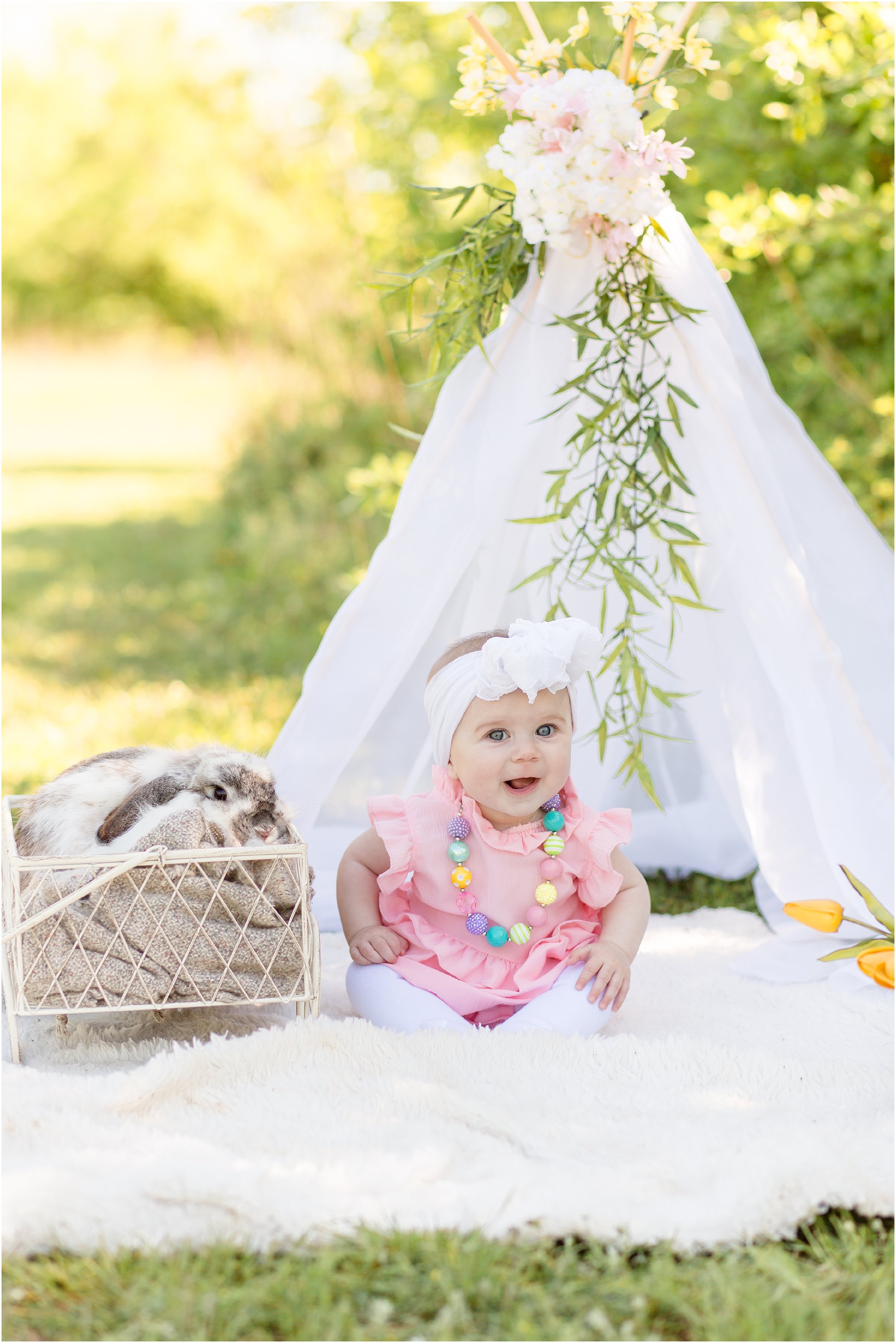 kids with live bunny in a field with a white teepee