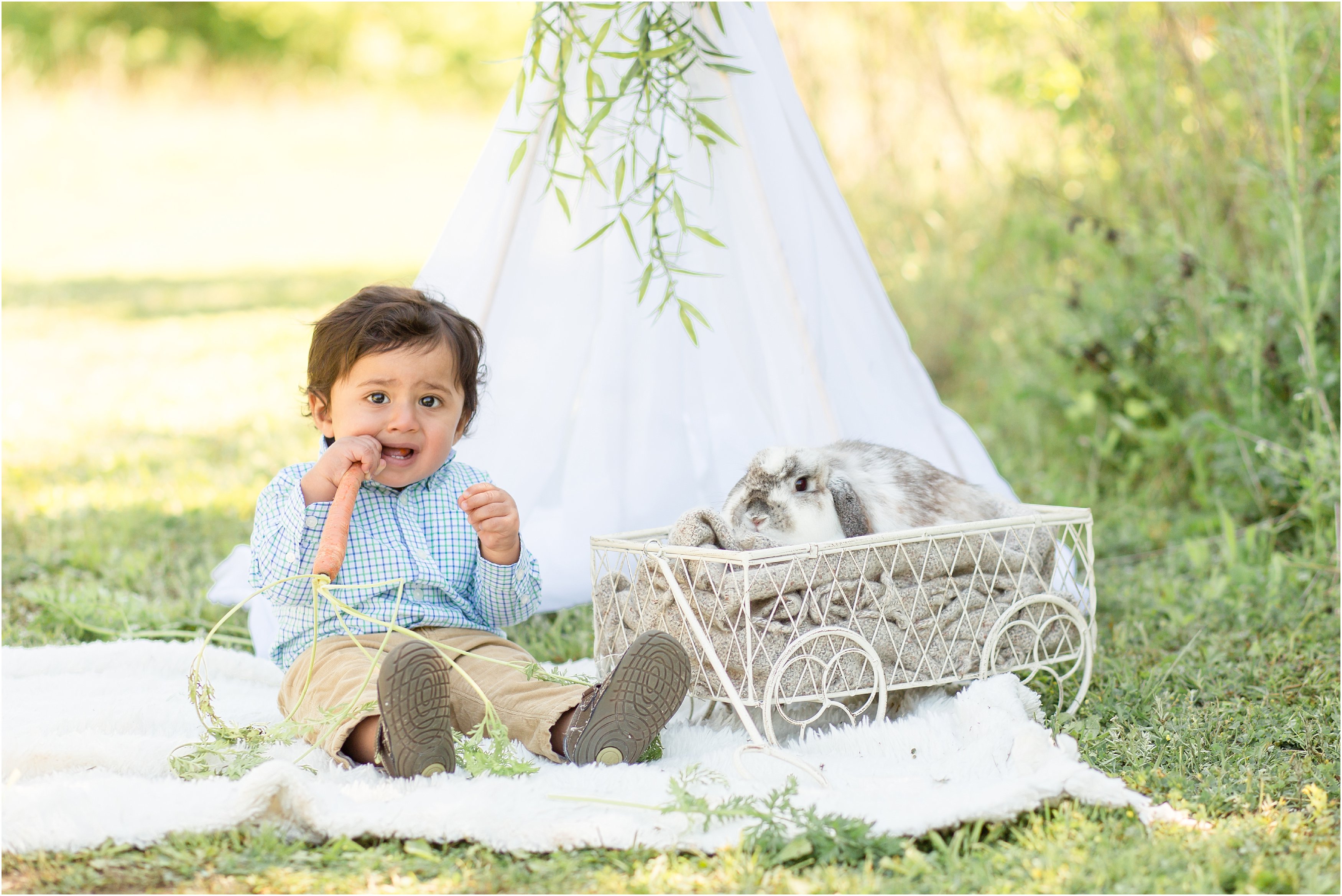 kids with live bunny in a field with a white teepee