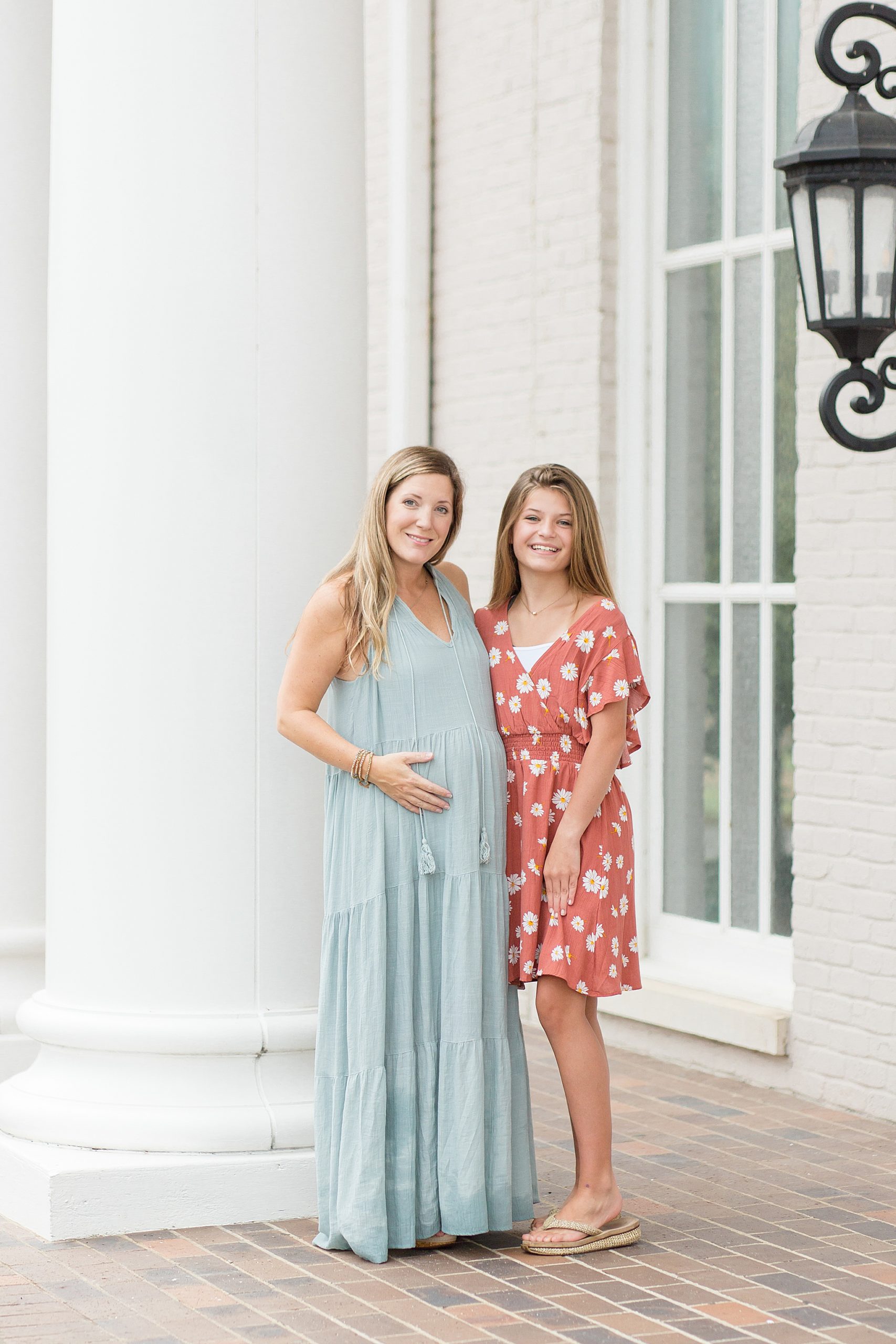 pregnant mom poses with teenage daughter in downtown Franklin Square