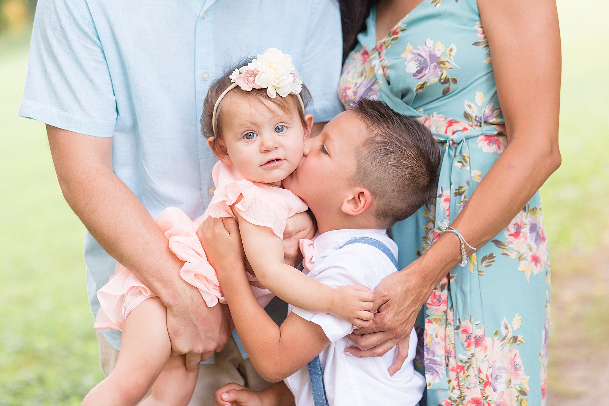 big brother kisses baby sister during Pinkerton Park family portraits