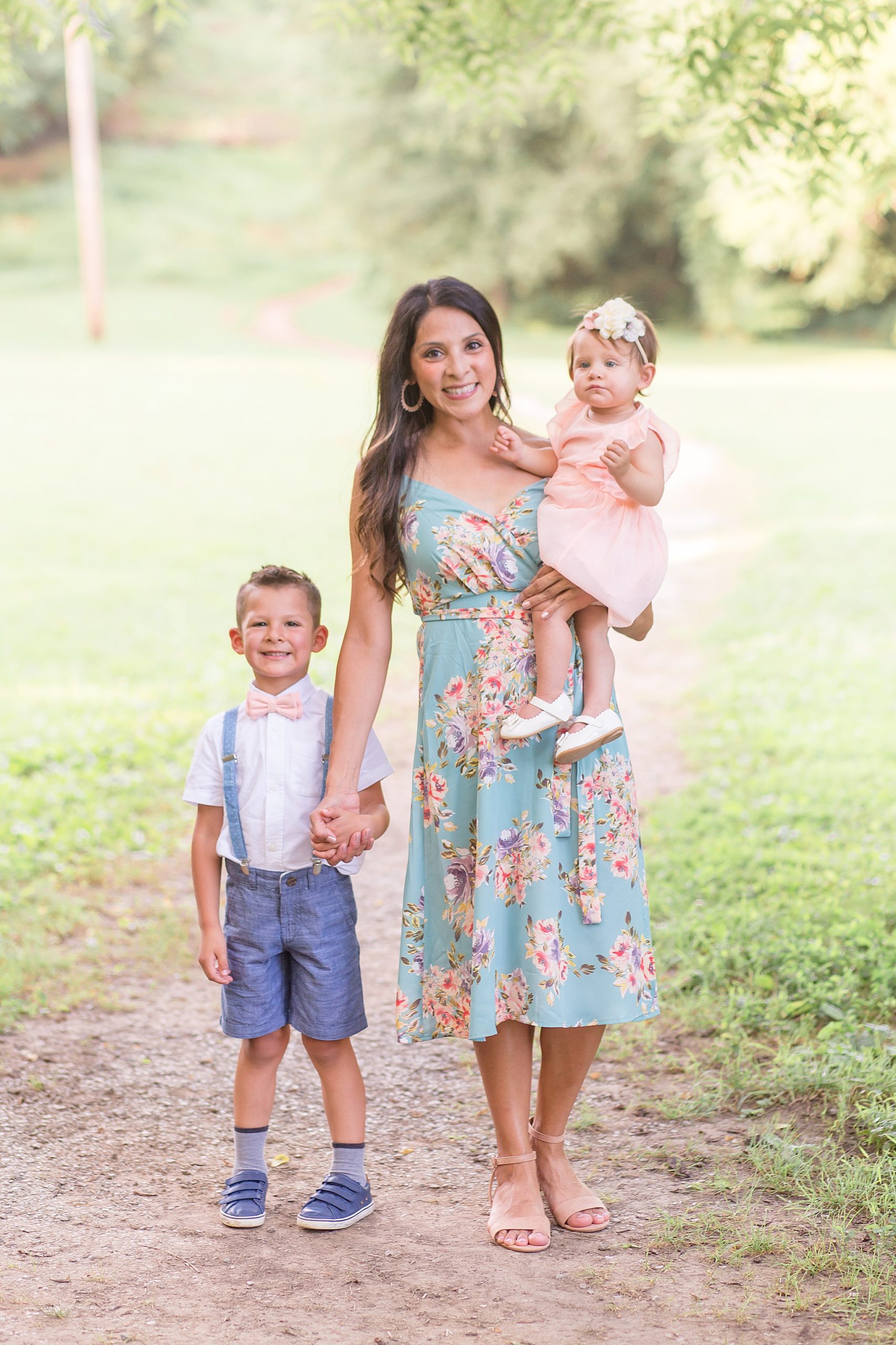 mom walks with toddler girl and son during Pinkerton Park family portraits