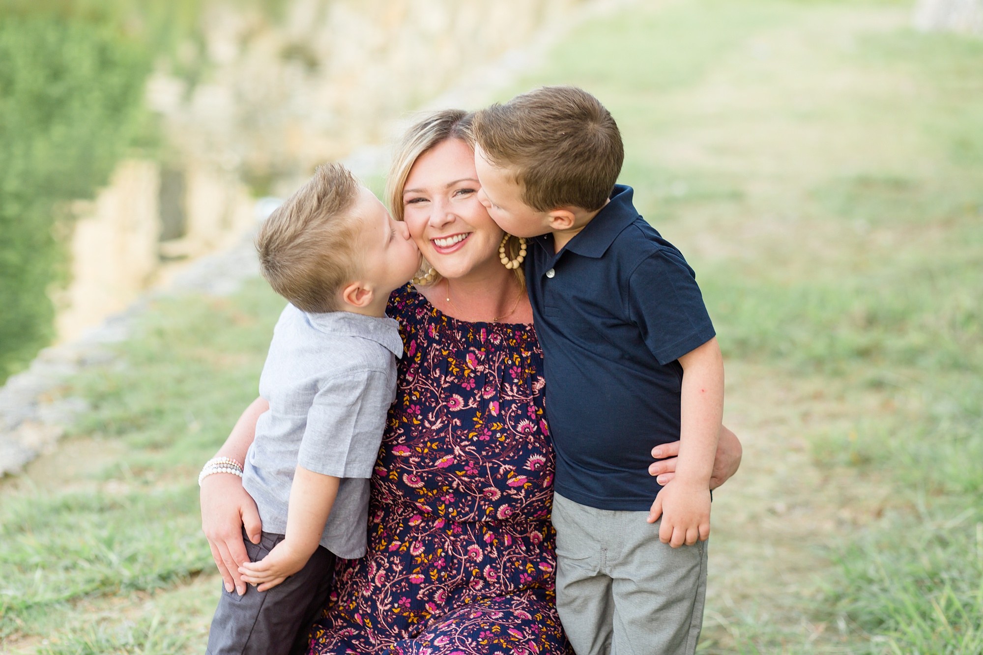 sons kiss mom during fall mini session in Texas