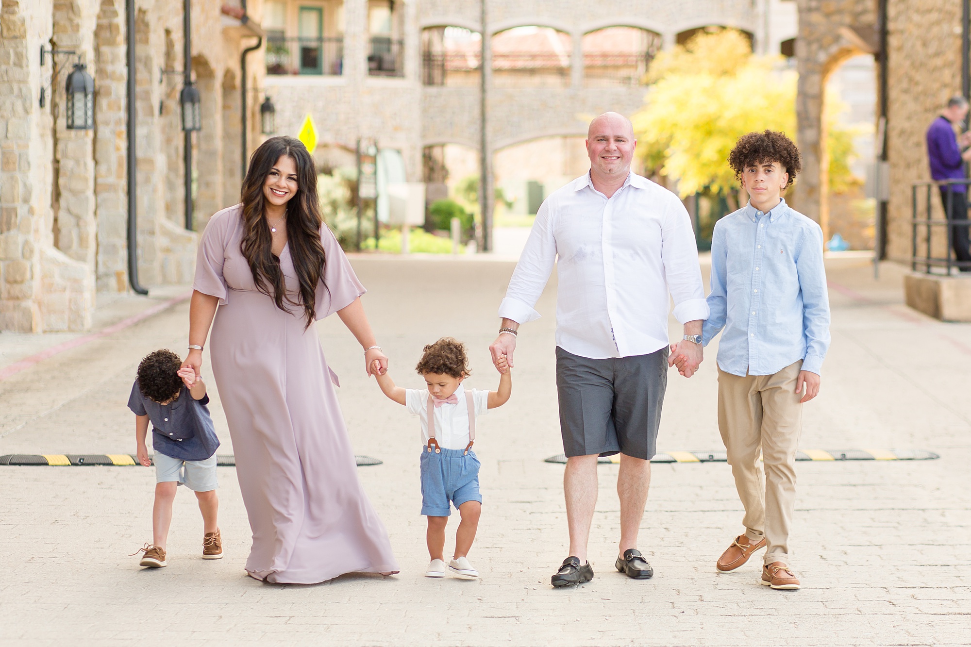 family of five walks through Adriatica Village