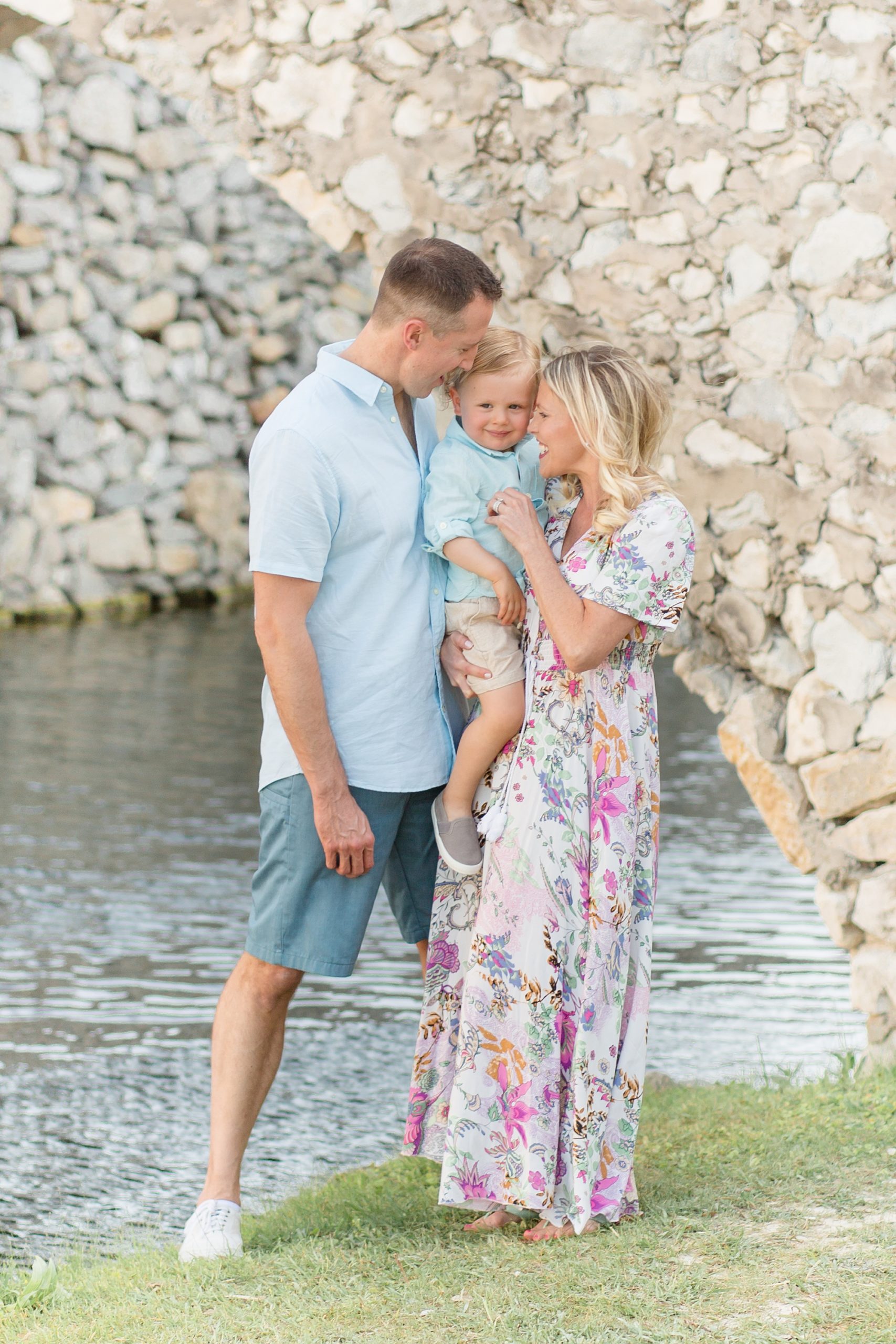 parents kiss toddler during Adriatica Village family session