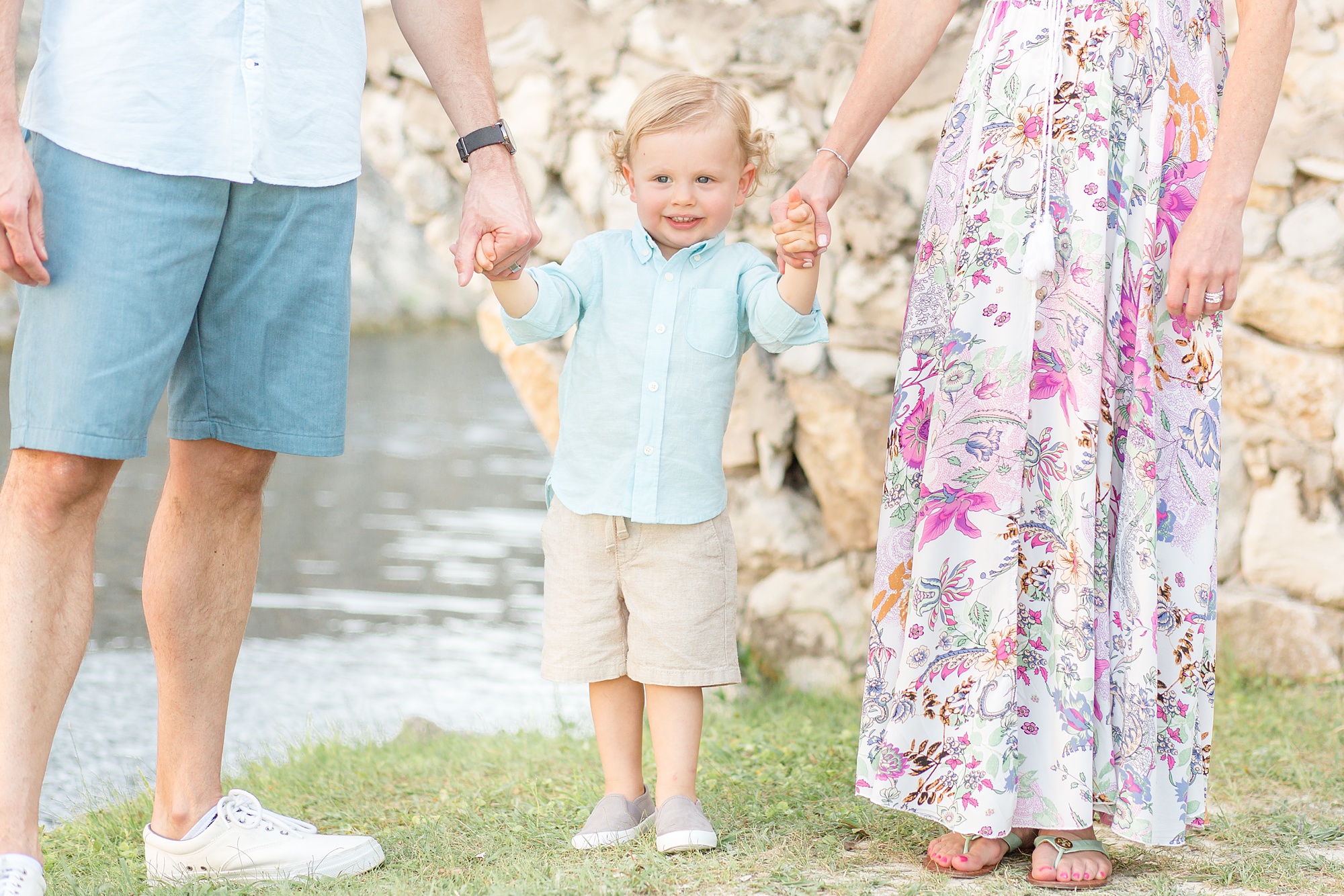 boy holds mom and dads hands during family photos in Texas
