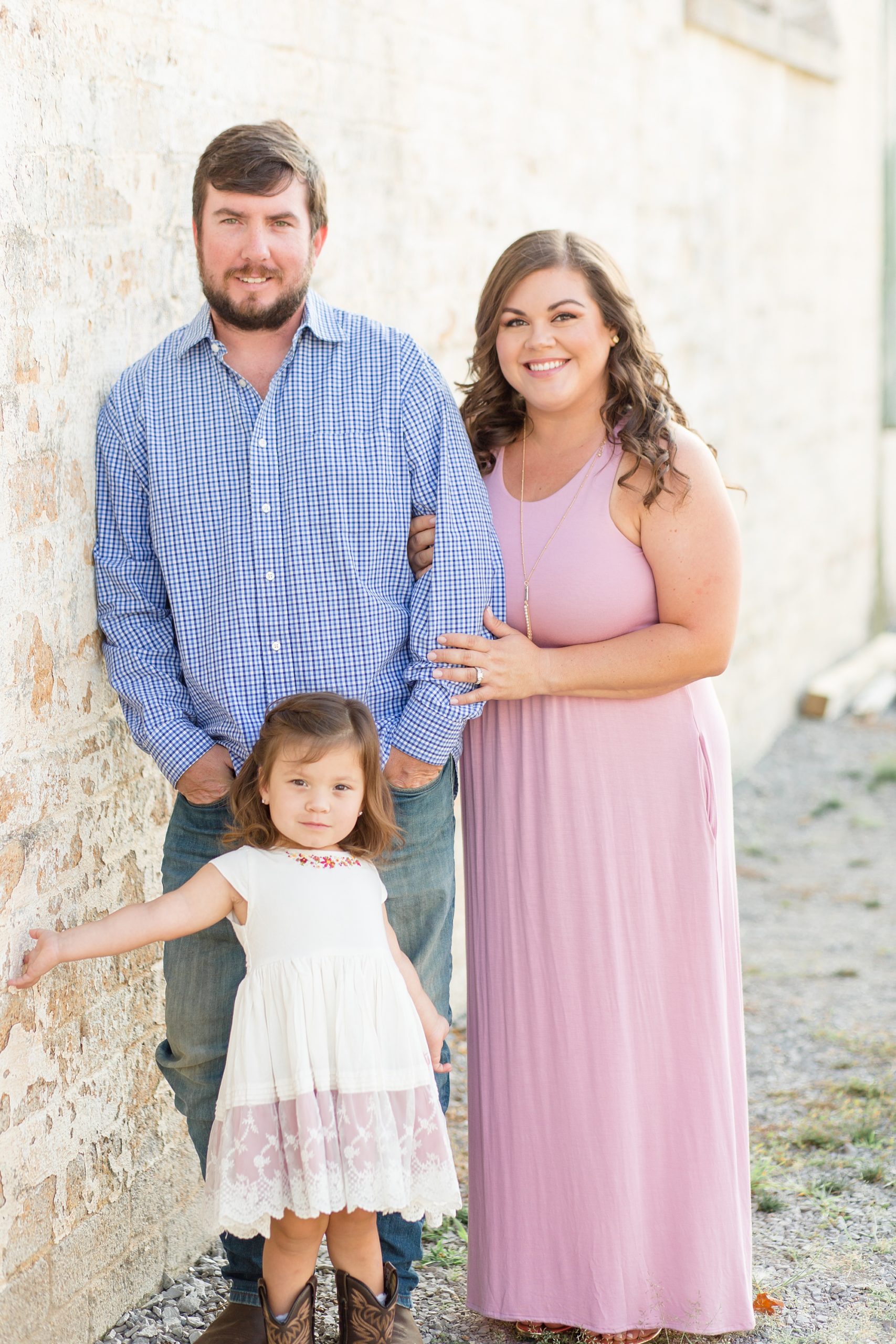 mom holds dad's elbow during family portraits in Franklin TN