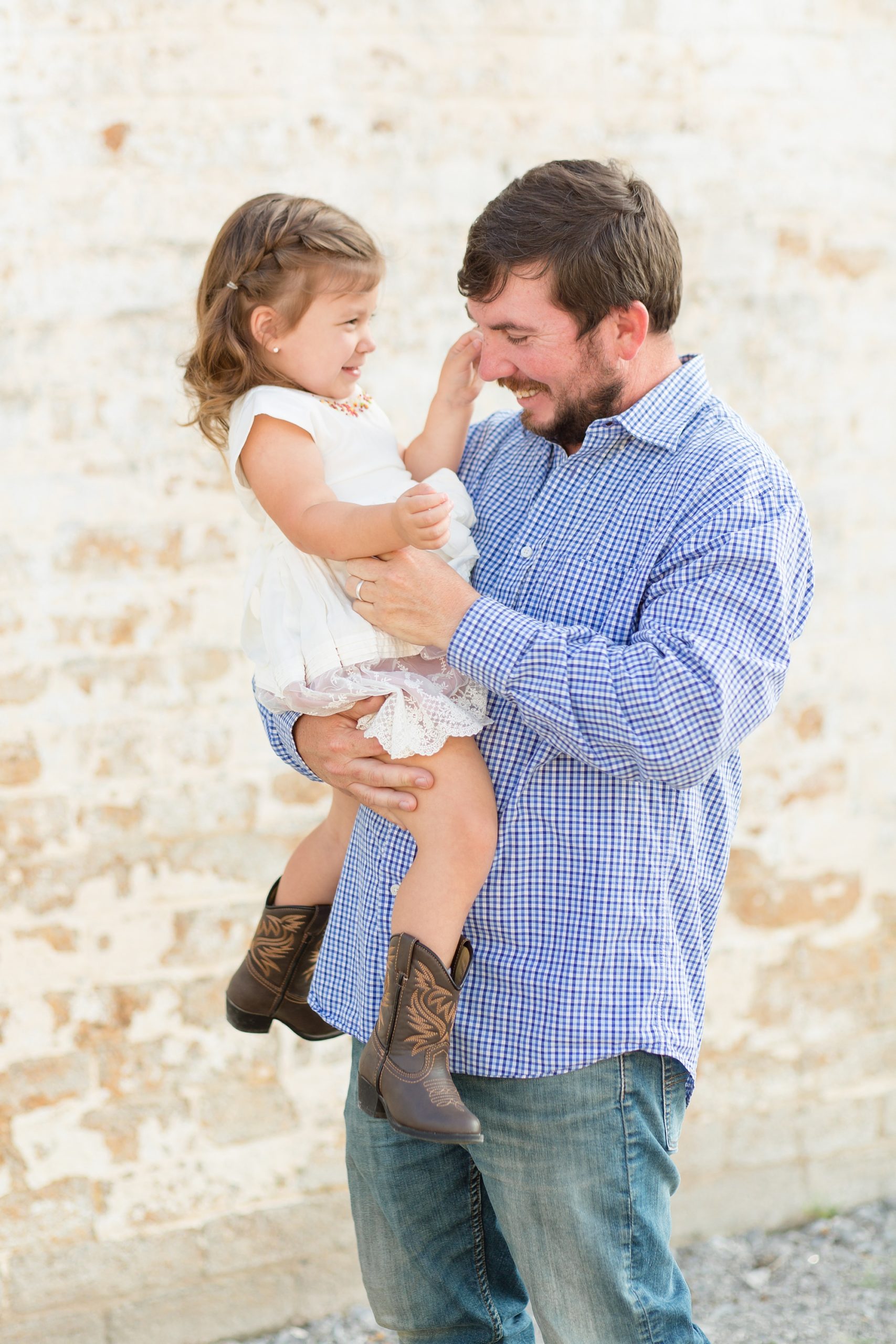 dad and daughter play during family photos with Rebecca Rice Photography