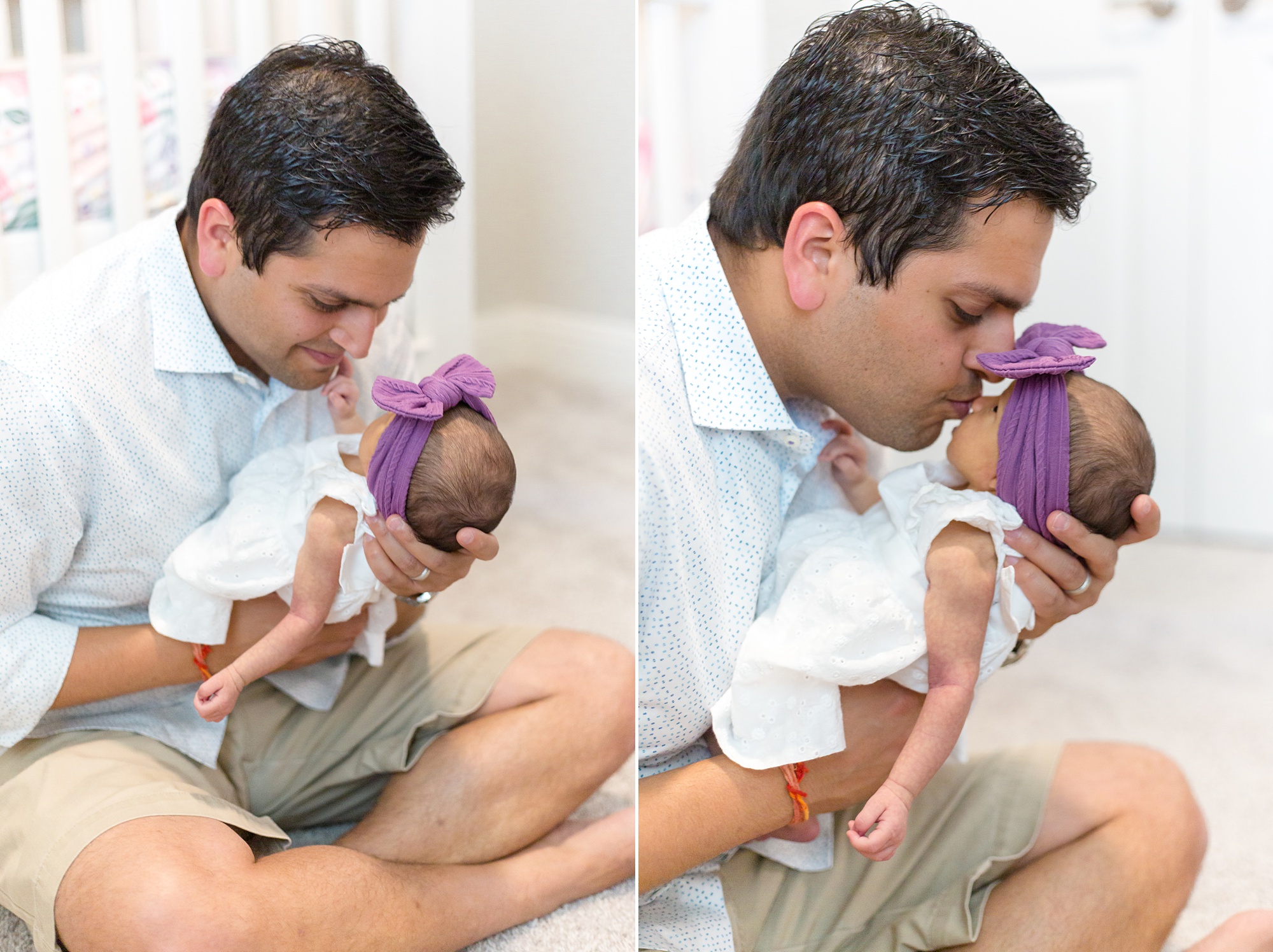 dad holds newborn baby girl in nursery