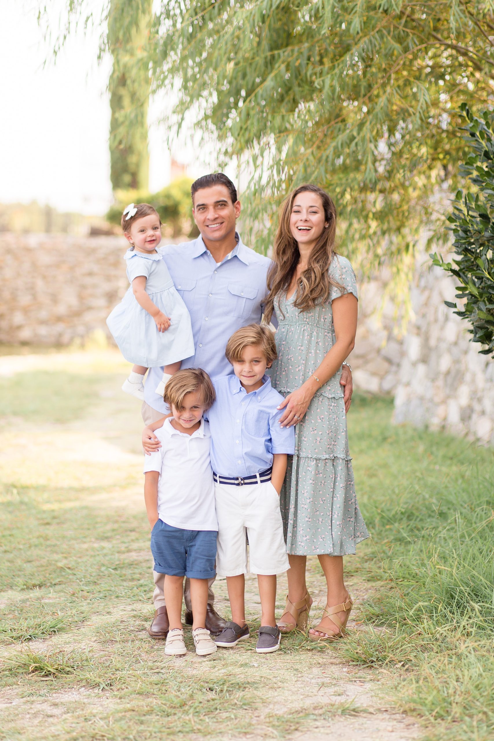 family of five poses in Adriatica Village