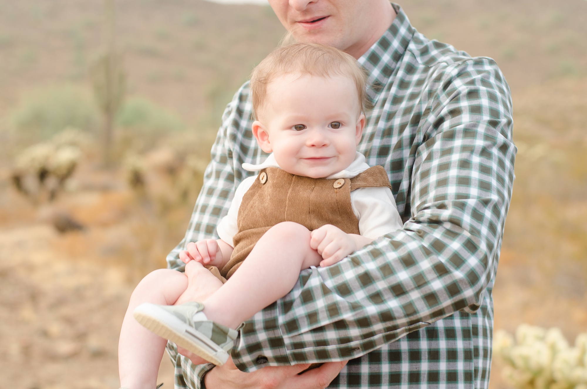 son sits in dad's arms during AZ family photos