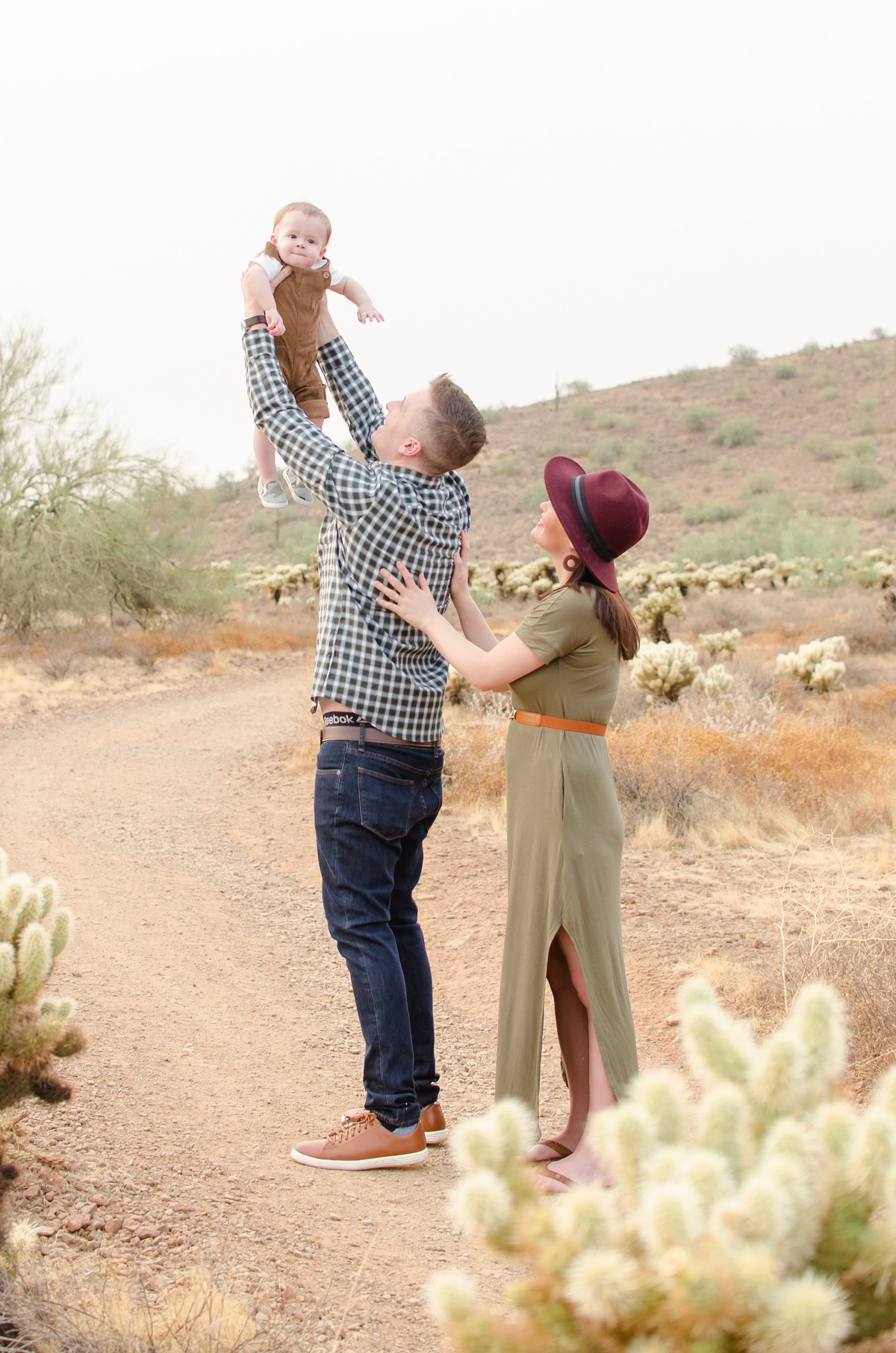 dad lifts baby up in the air during family photos