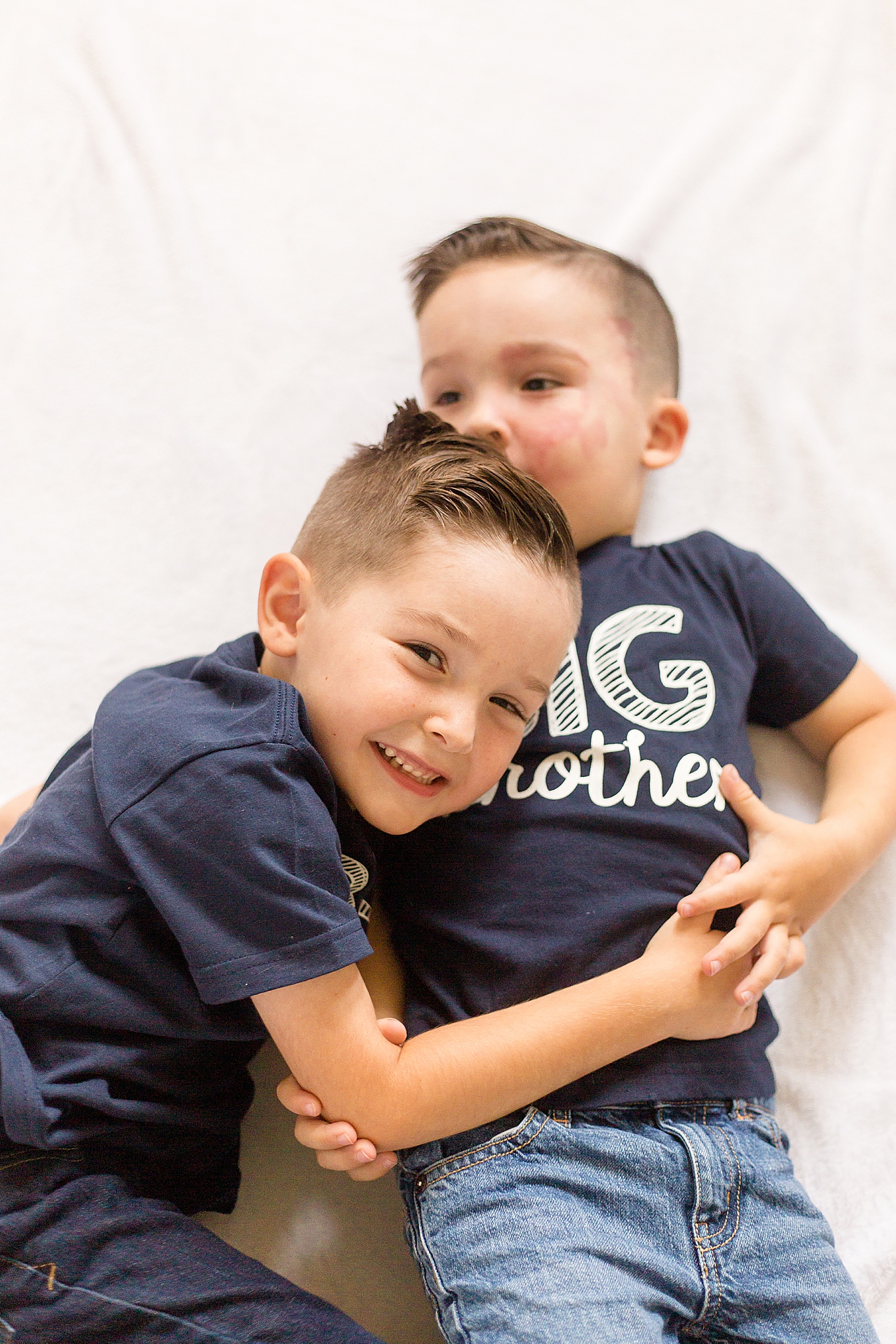 big brothers laugh during newborn session