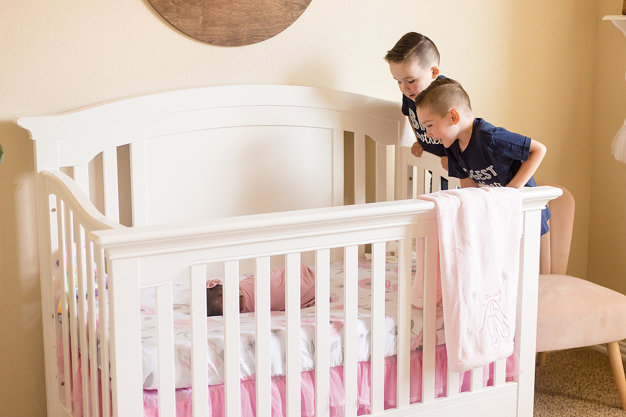 big brothers look into crib during At Home Lifestyle Newborn Session