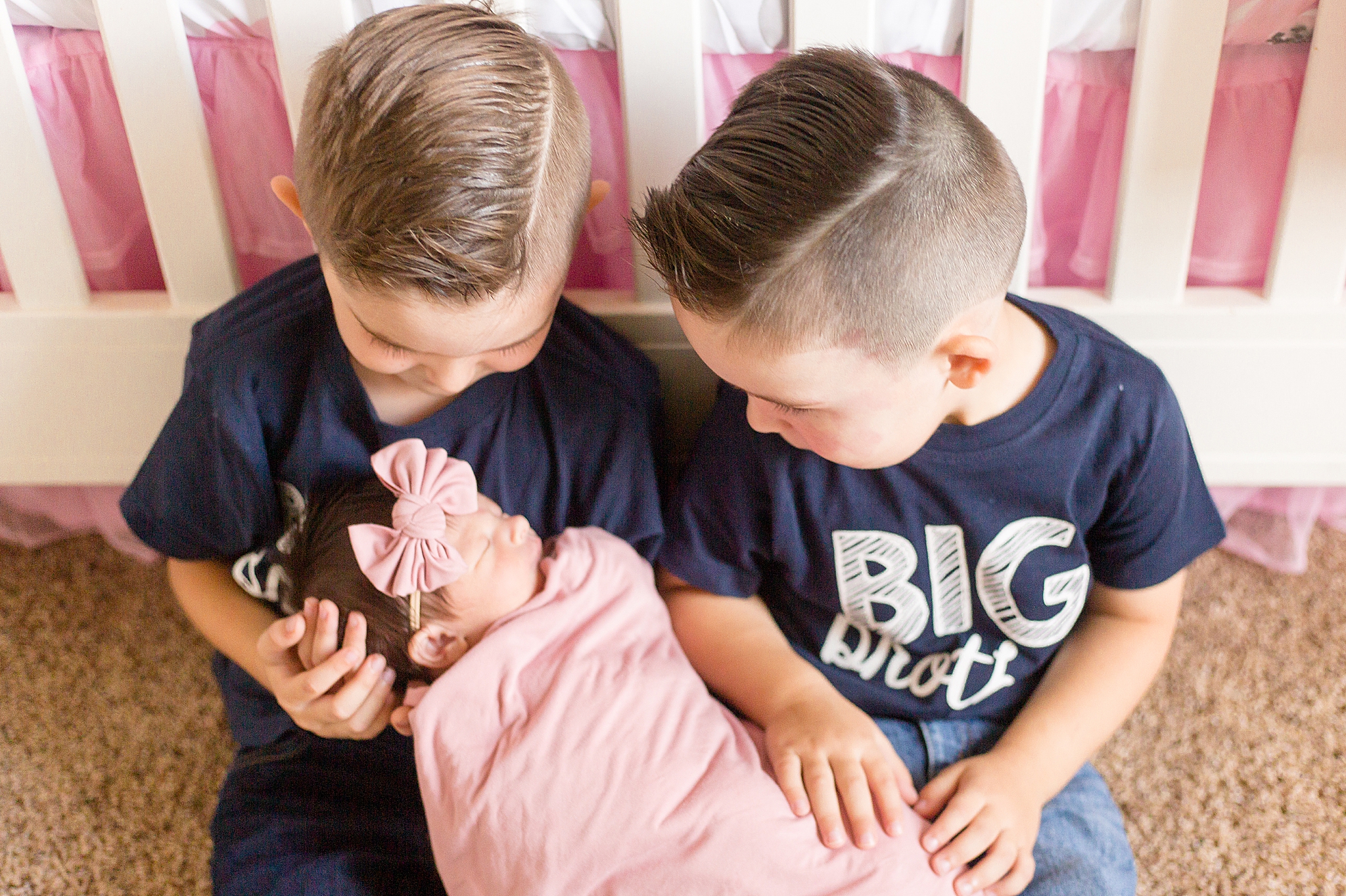 brothers look at newborn sister during At Home Lifestyle Newborn Session