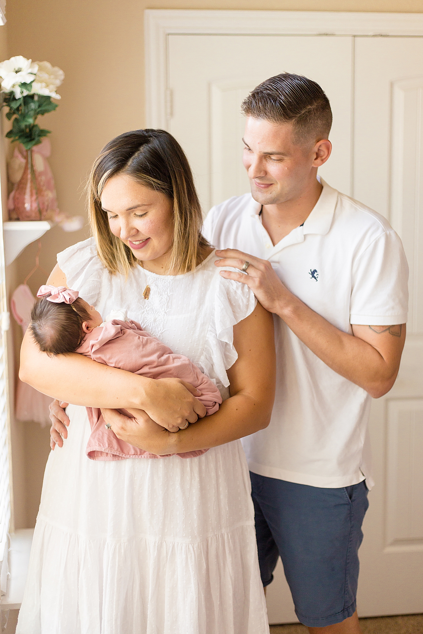 parents look at new baby girl during lifestyle photos
