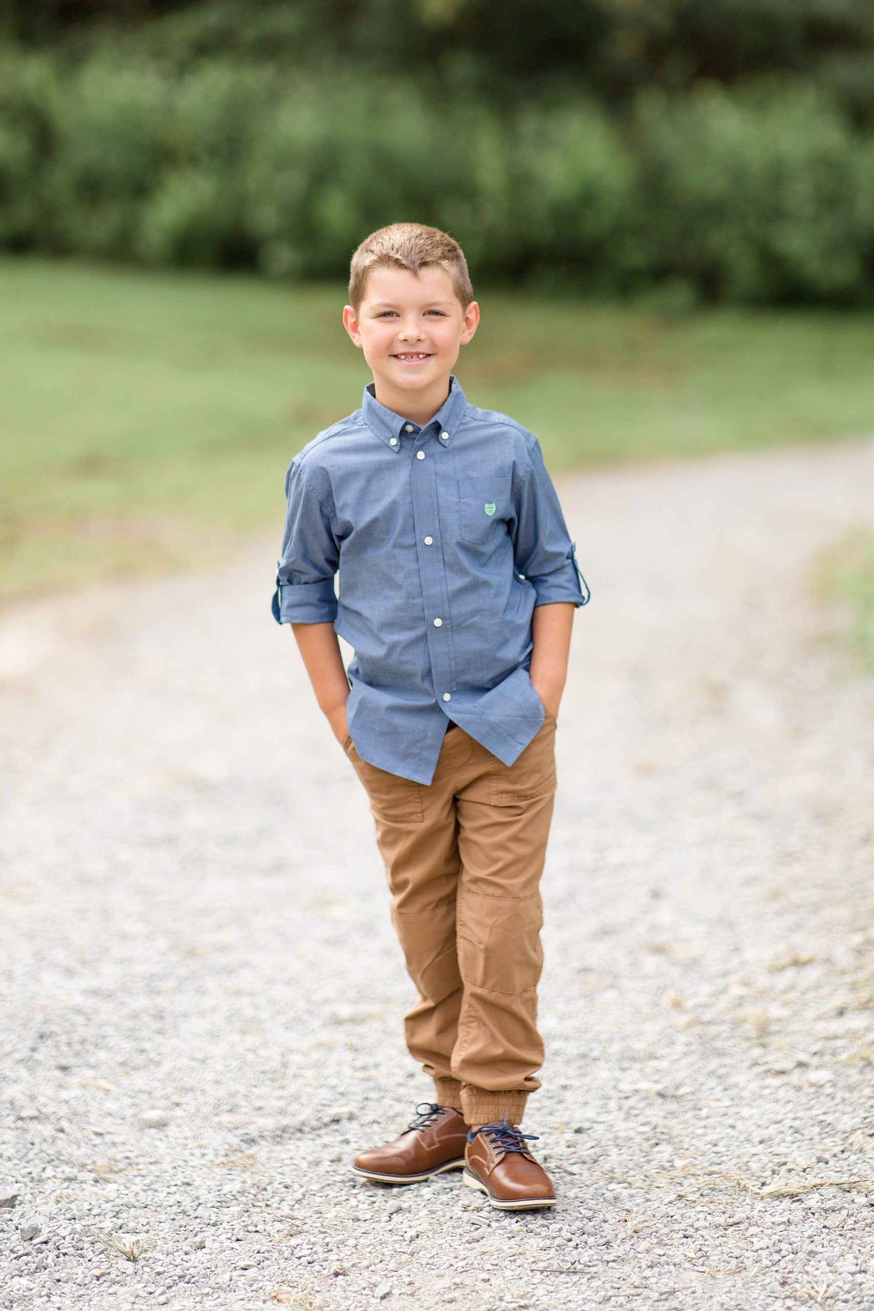 little boy poses in park during Nashville TN family photos