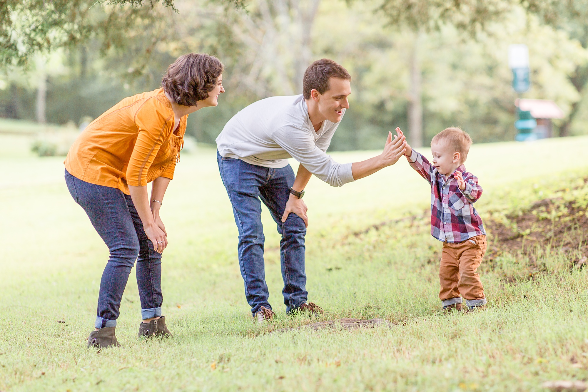 parents high five toddler during family portraits