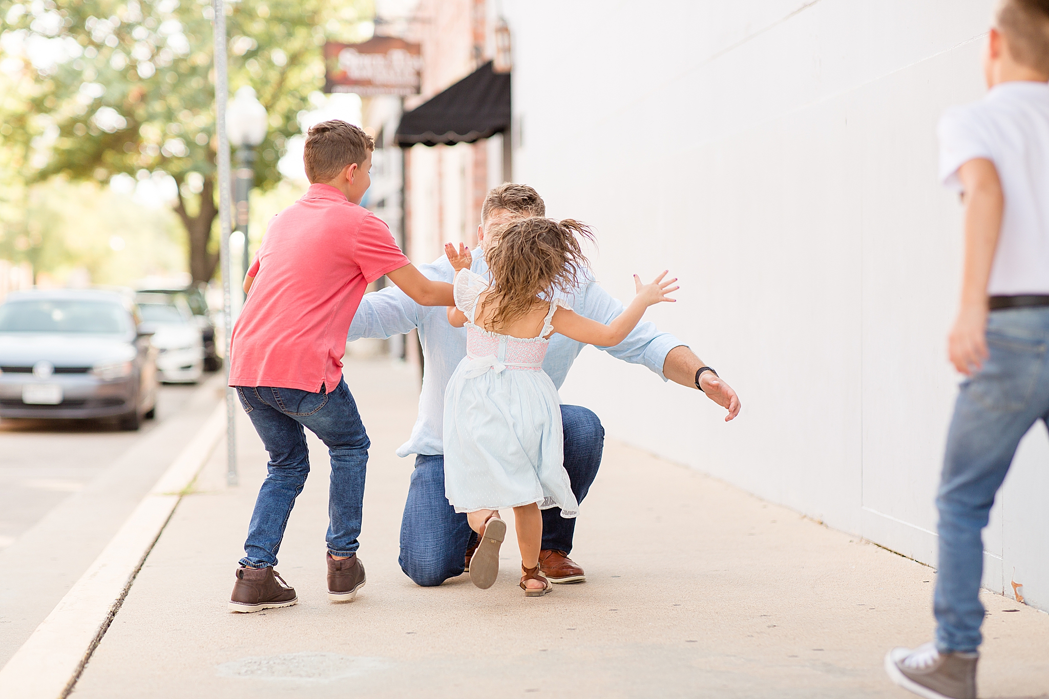 kids run to dad during Downtown McKinney Square Fall Minis