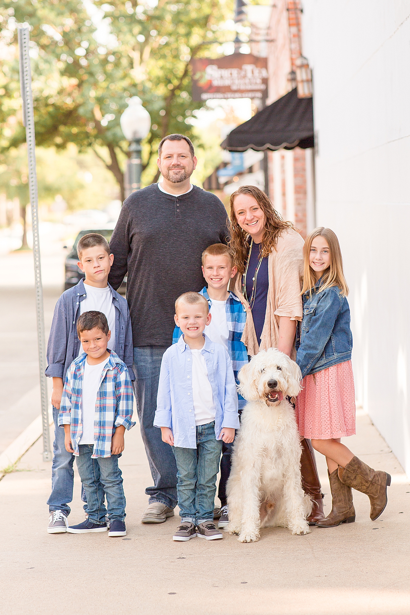 family poses with dog during Downtown McKinney Square mini sessions