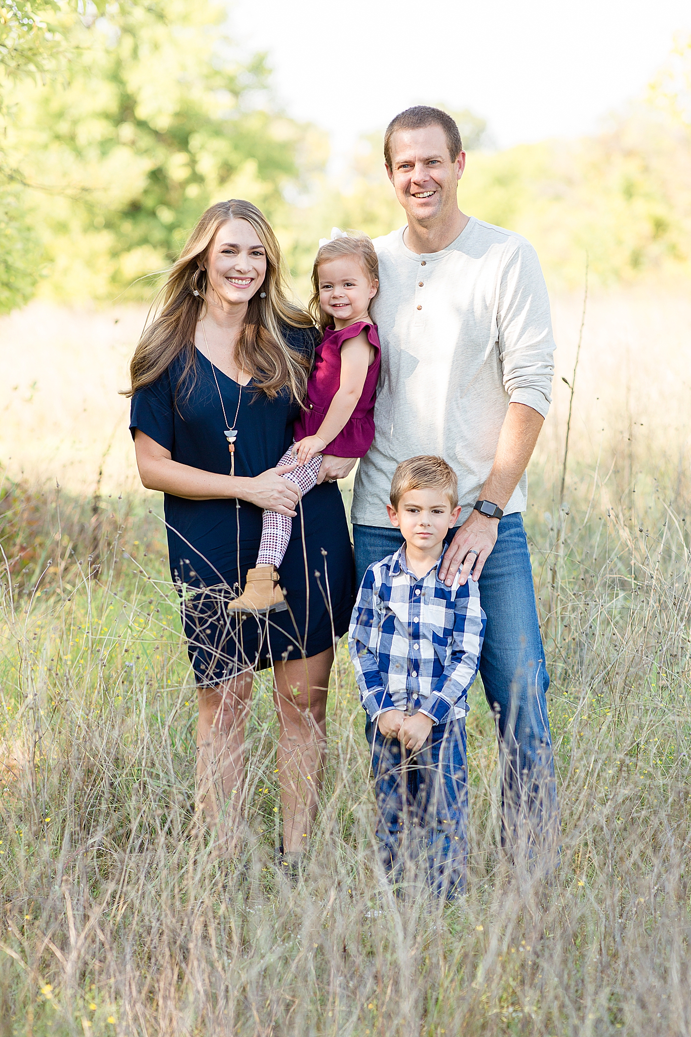 family poses in field during Frisco Commons Fall Minis