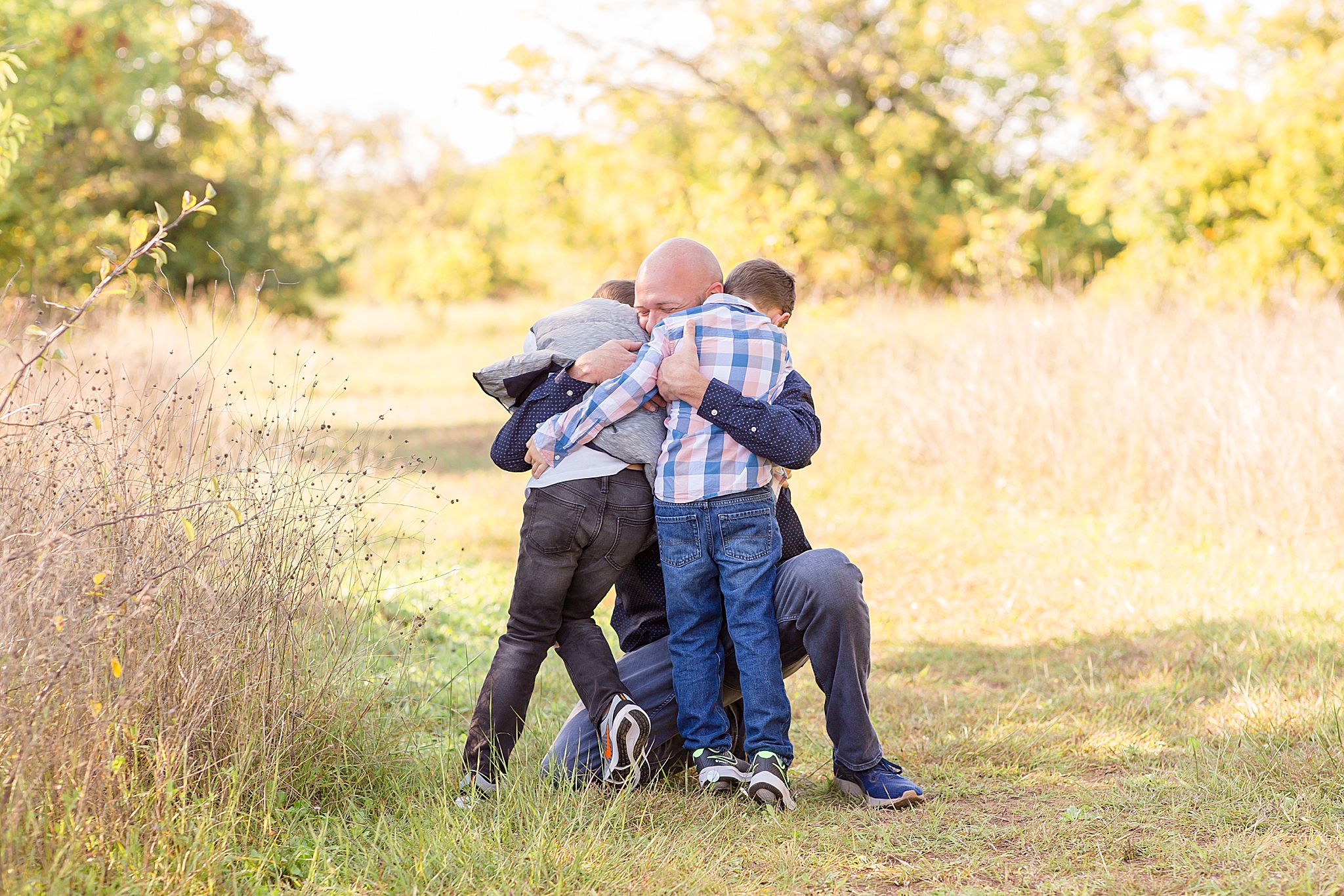 dad hugs boys as they run to him during TX mini session