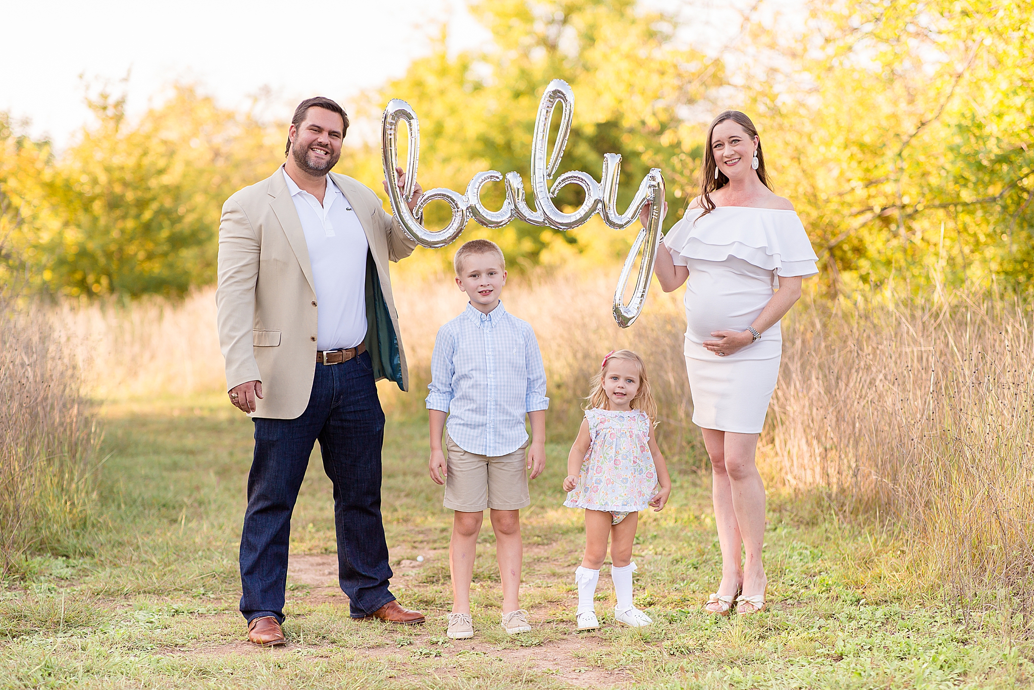 family announces baby during fall mini session