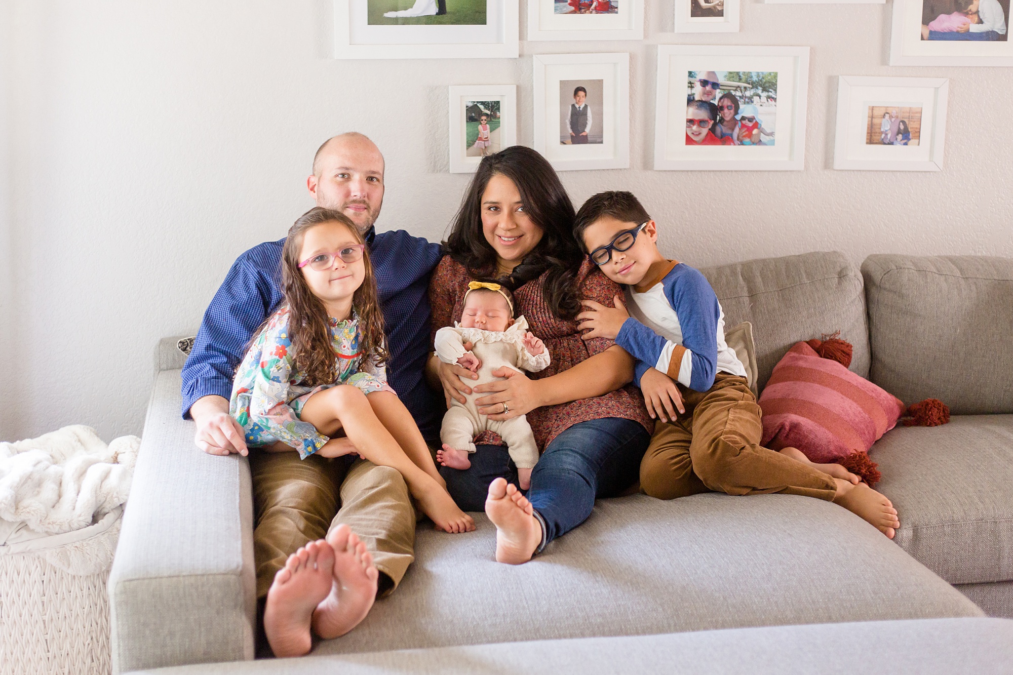 family of five sits on couch during lifestyle newborn session