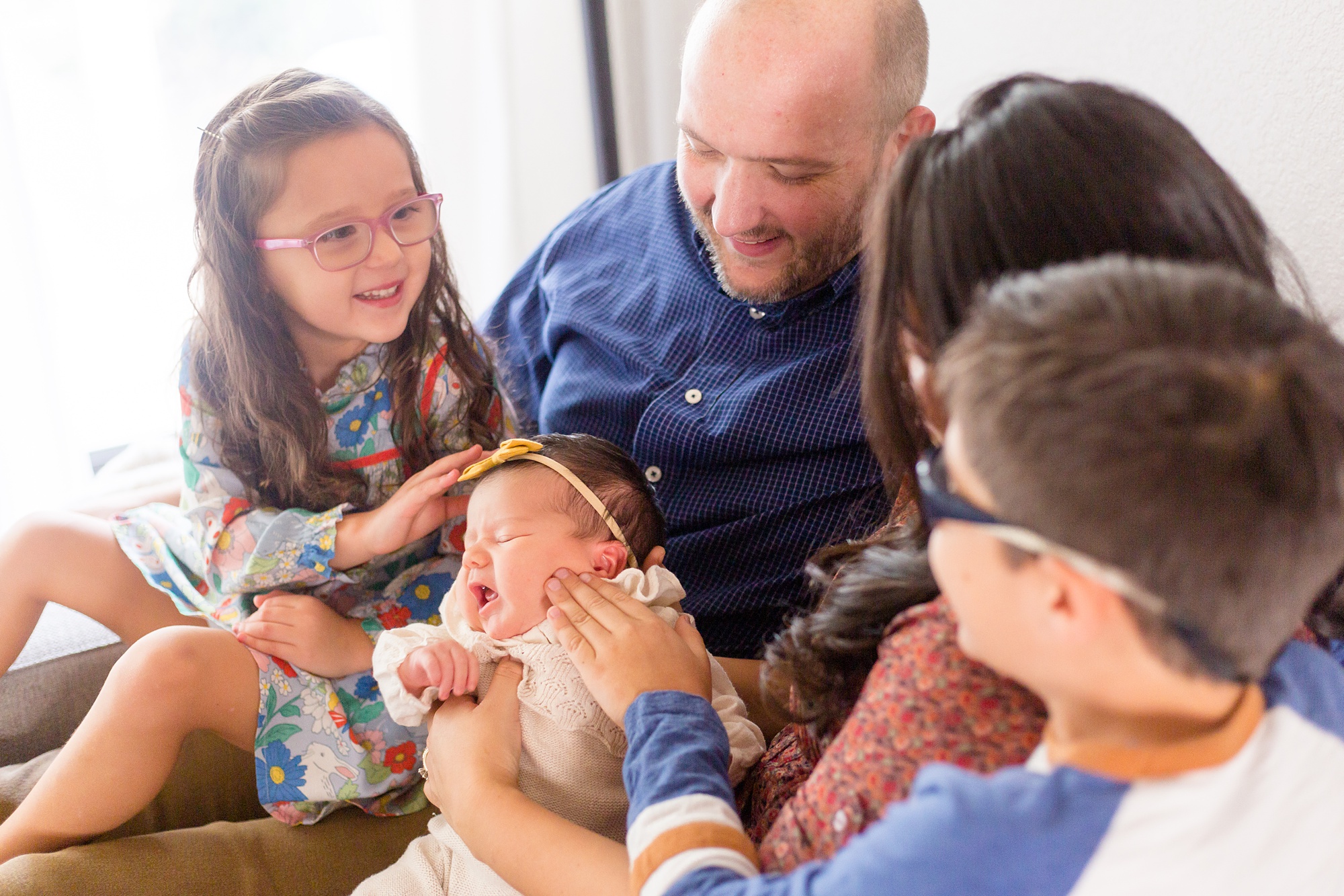 family looks at baby girl during lifestyle newborn session