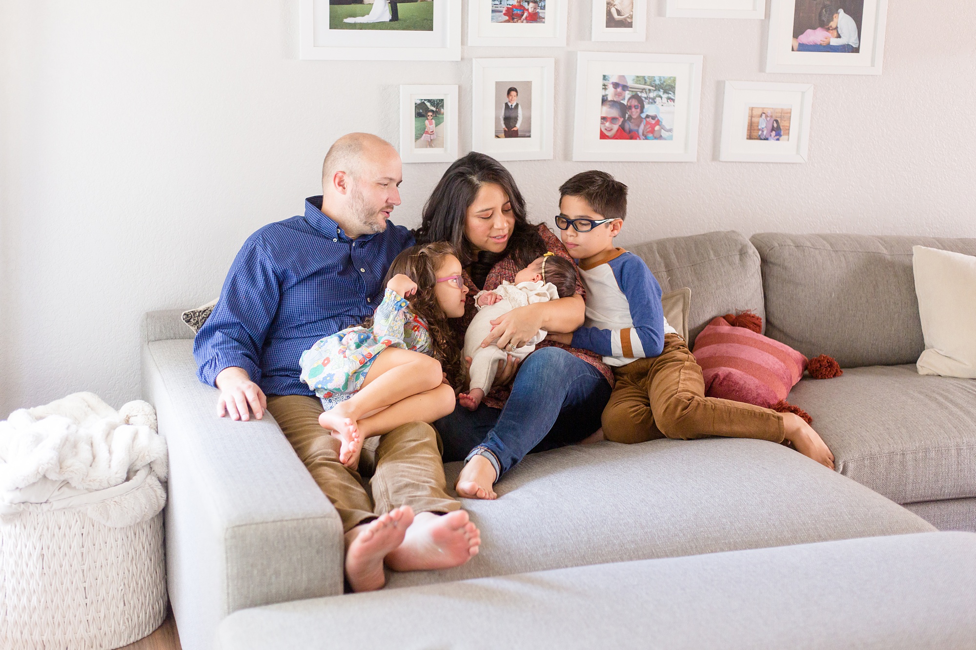 parents hold newborn baby girl during portraits at home
