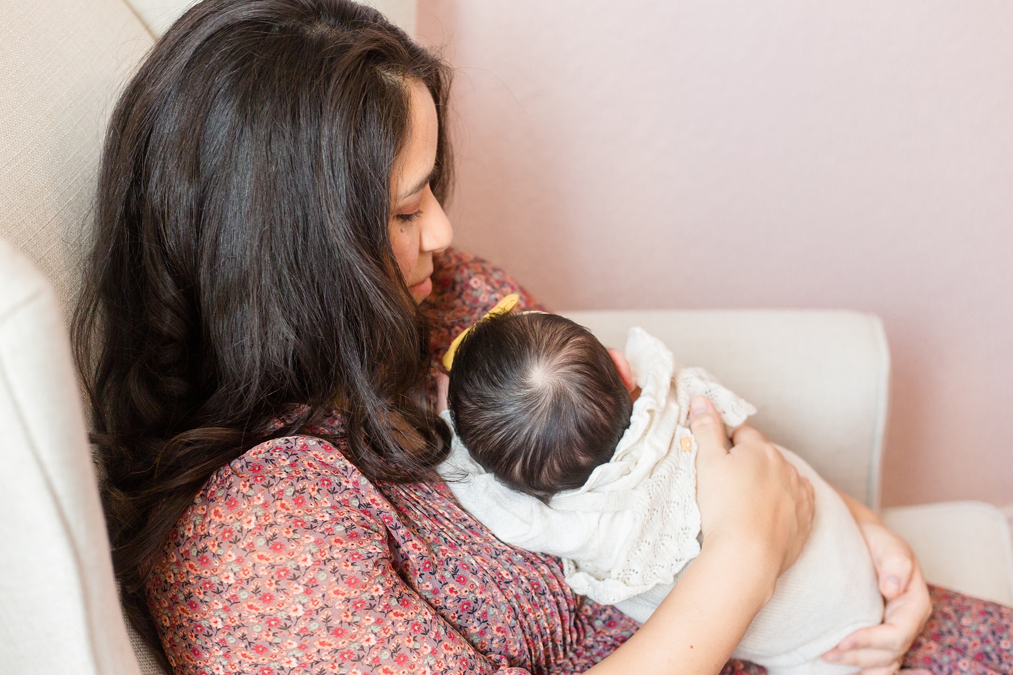 mom rocks baby girl during lifestyle newborn session