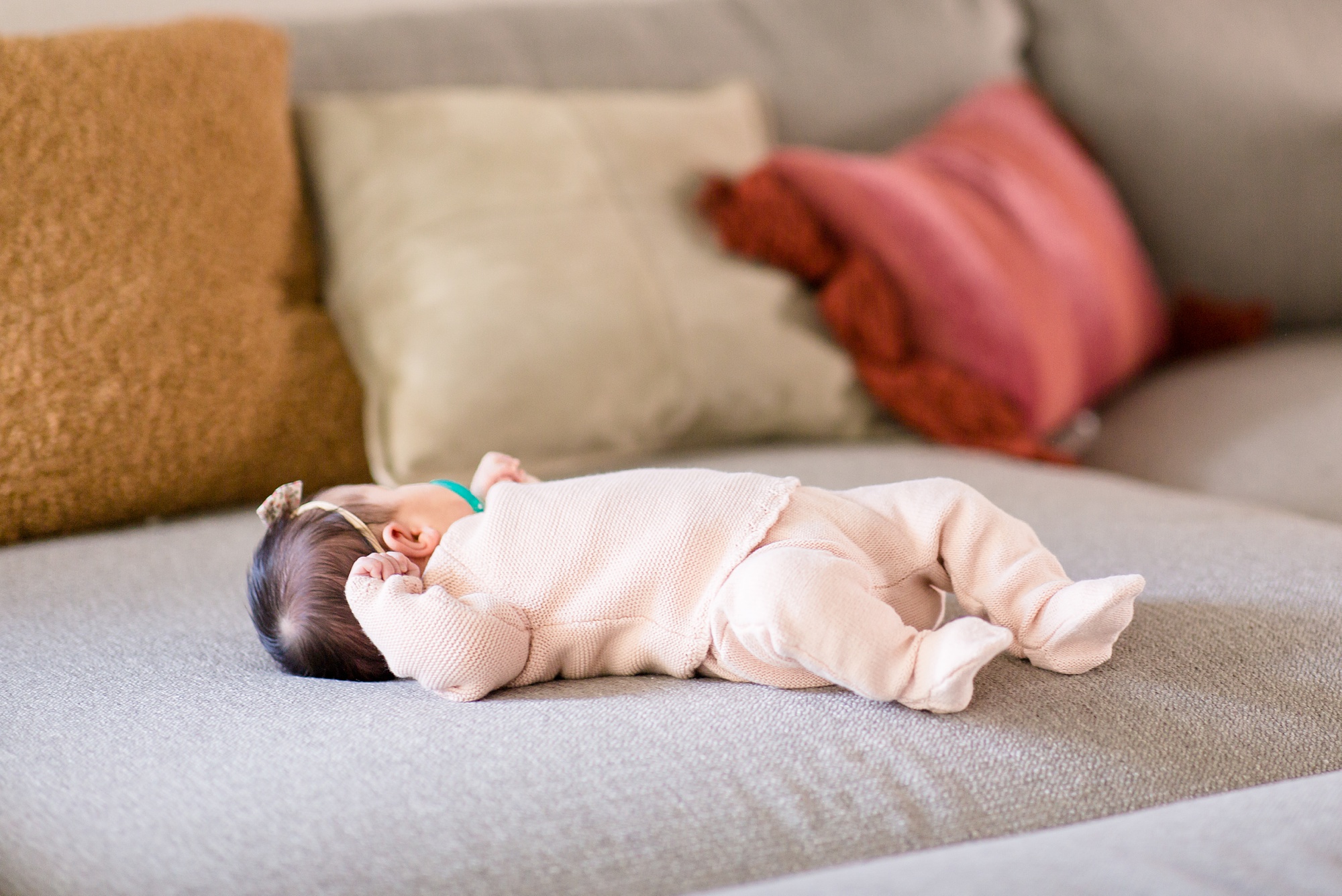 baby rests on couch during lifestyle newborn session