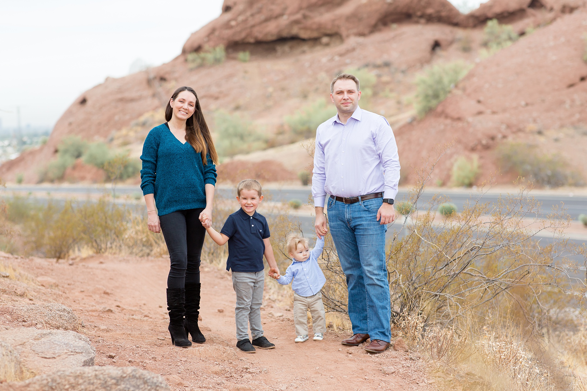family of four poses by road during Papago Park fall minis