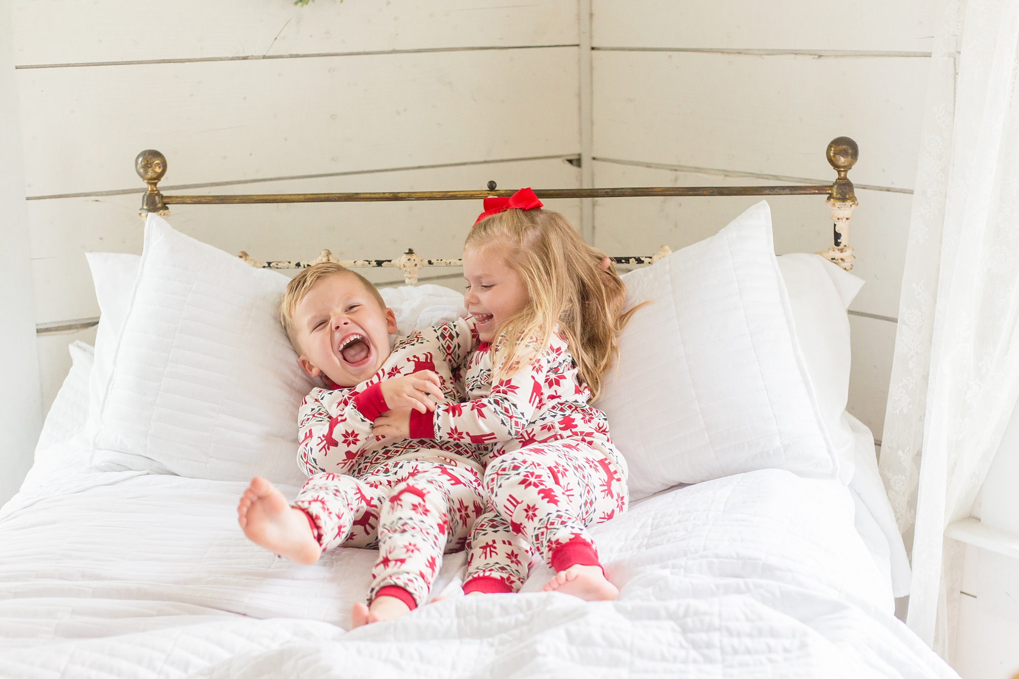siblings tickle each other during holiday mini session