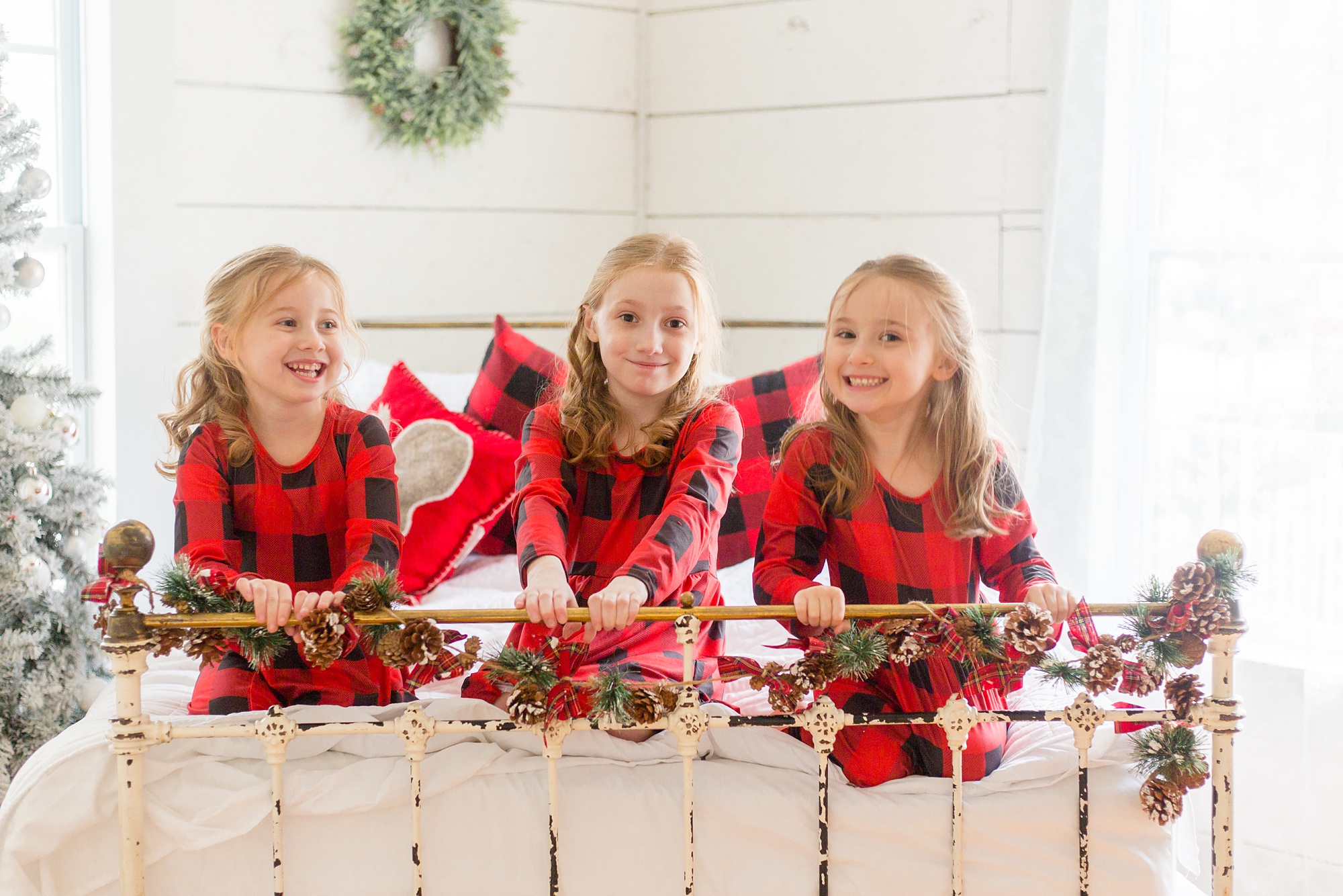 McKinney TX holiday mini session with sisters on bed