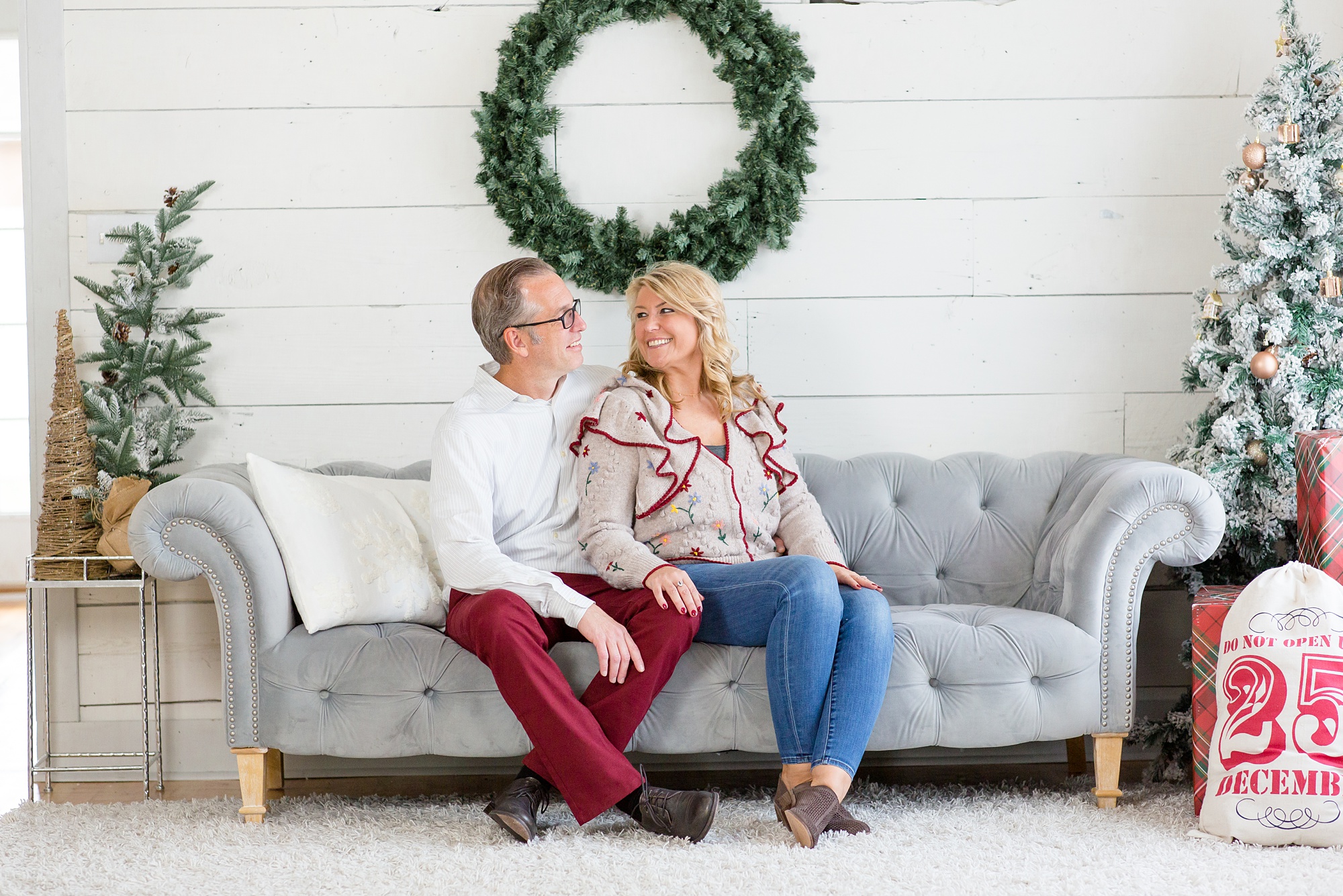 parents sit on couch during Studio House Christmas Minis