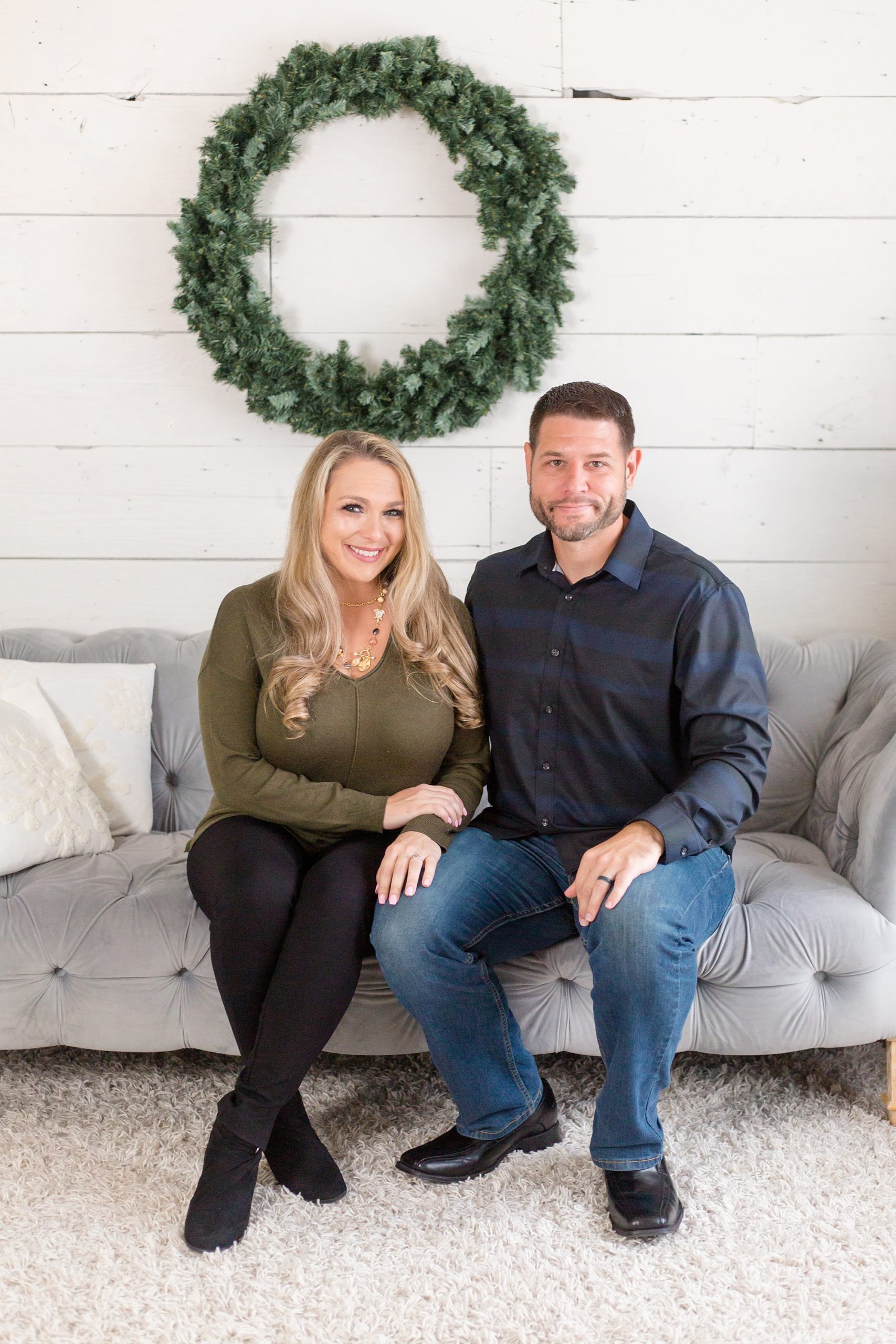 parents sit on couch during McKinney TX family photos