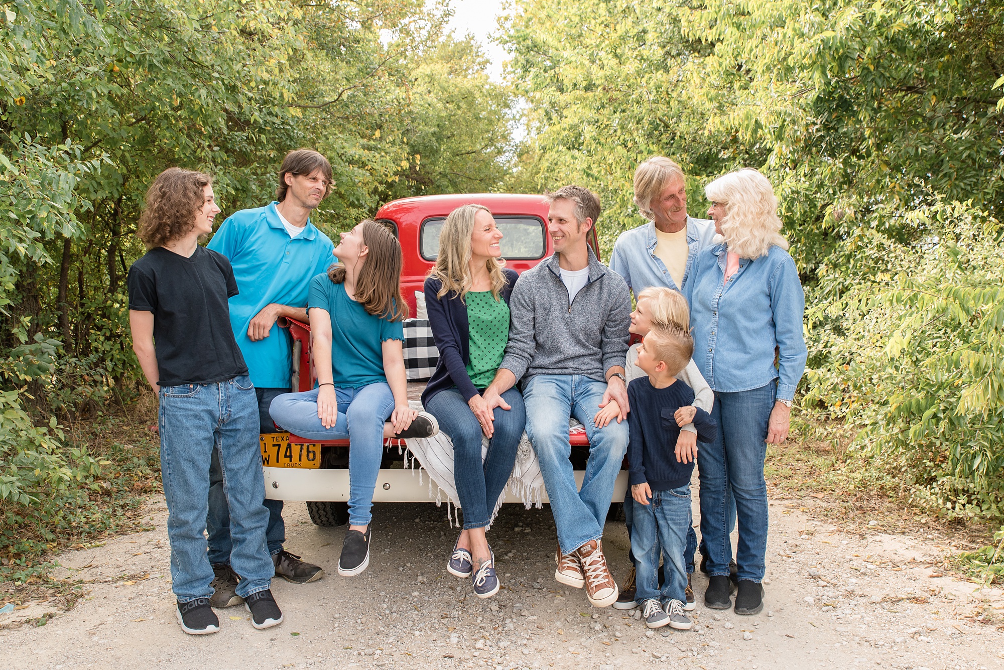 family with grandparents poses during Red Truck Christmas minis