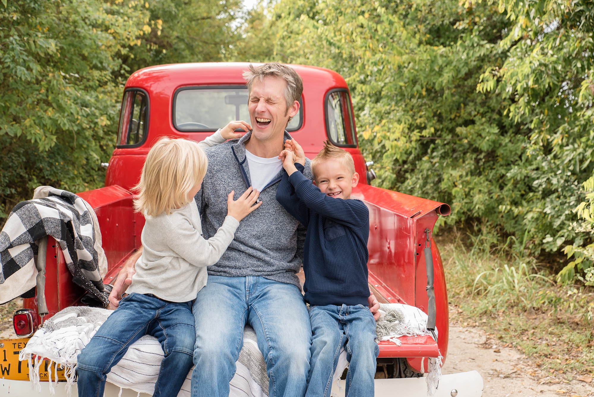 kids tickle dad during Red Truck Christmas minis