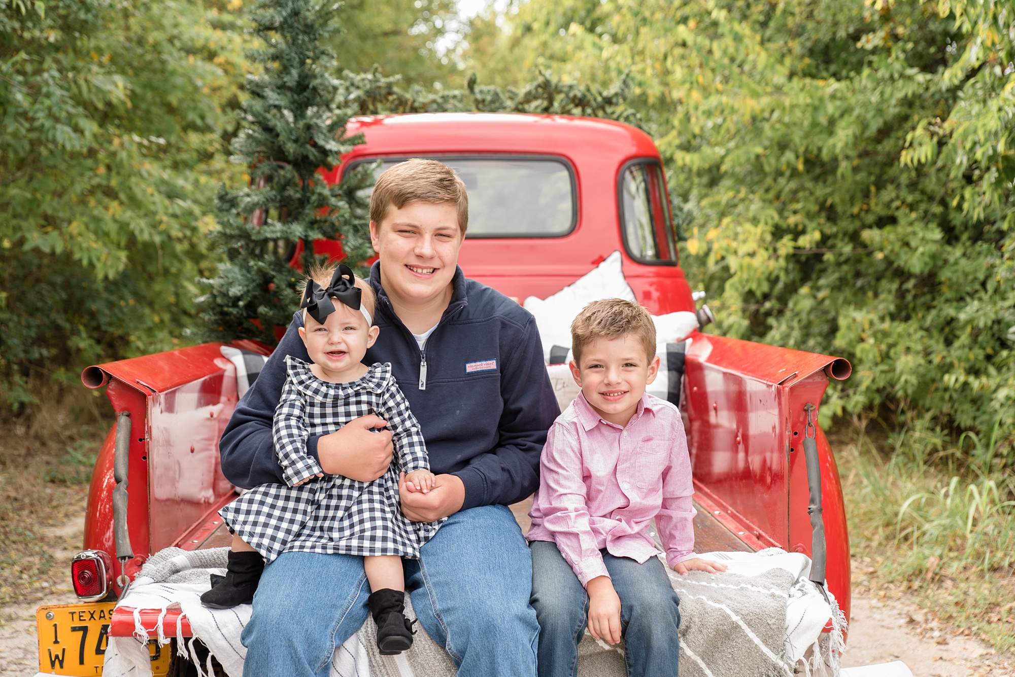 Red Truck Christmas minis with siblings sitting on truck bed