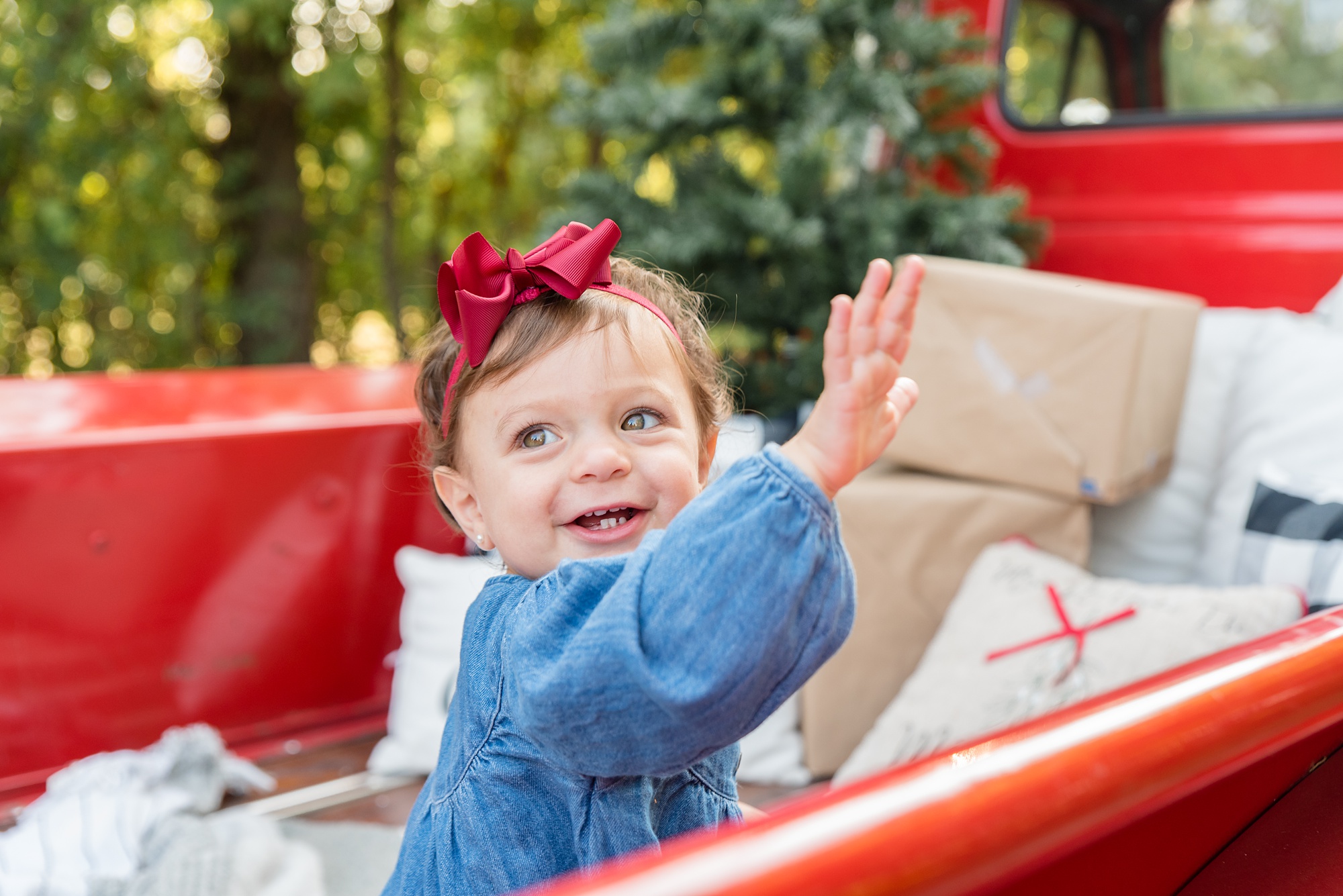 little girl in blue dress with red bow hits the side of truck