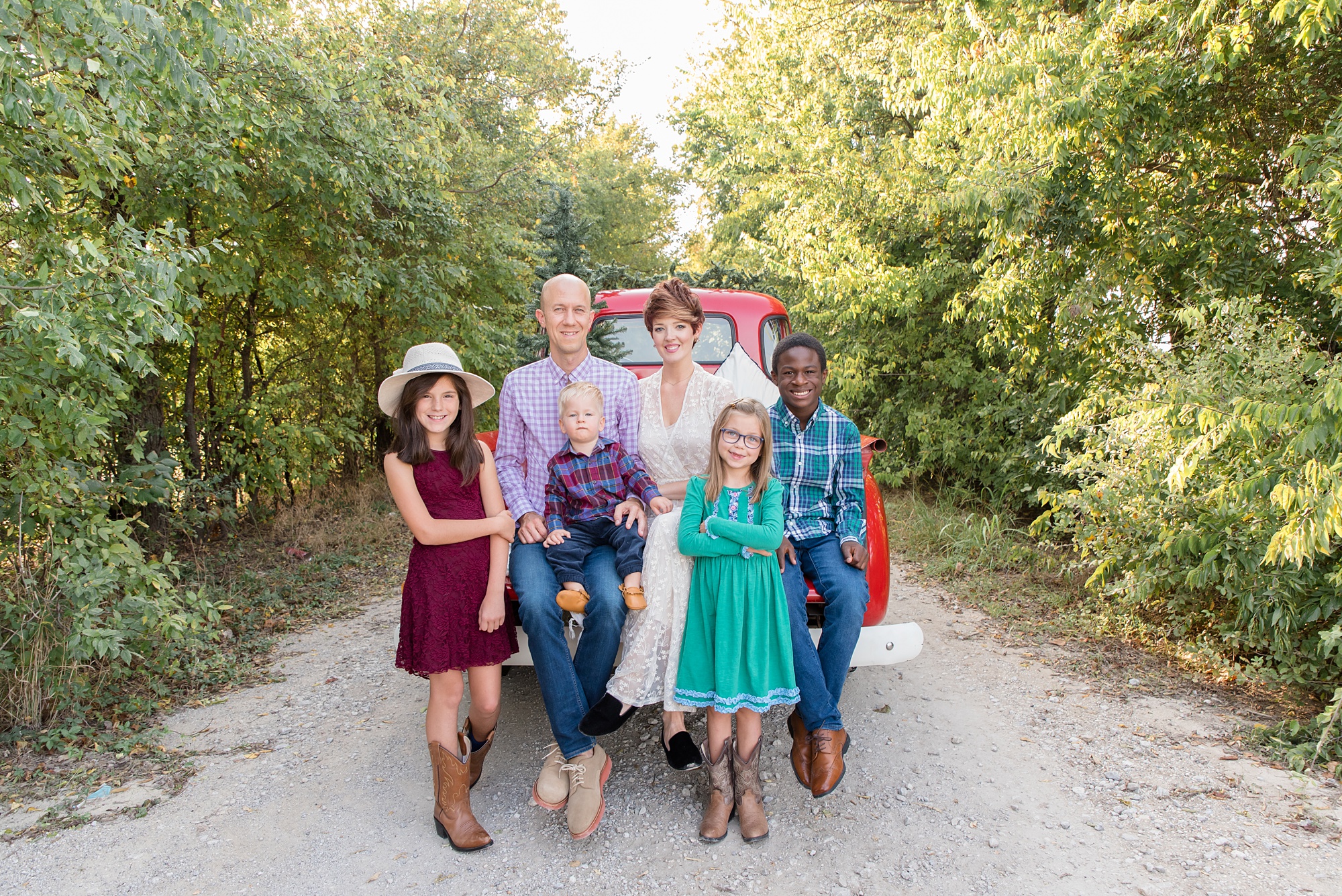 family of six poses during red truck mini session