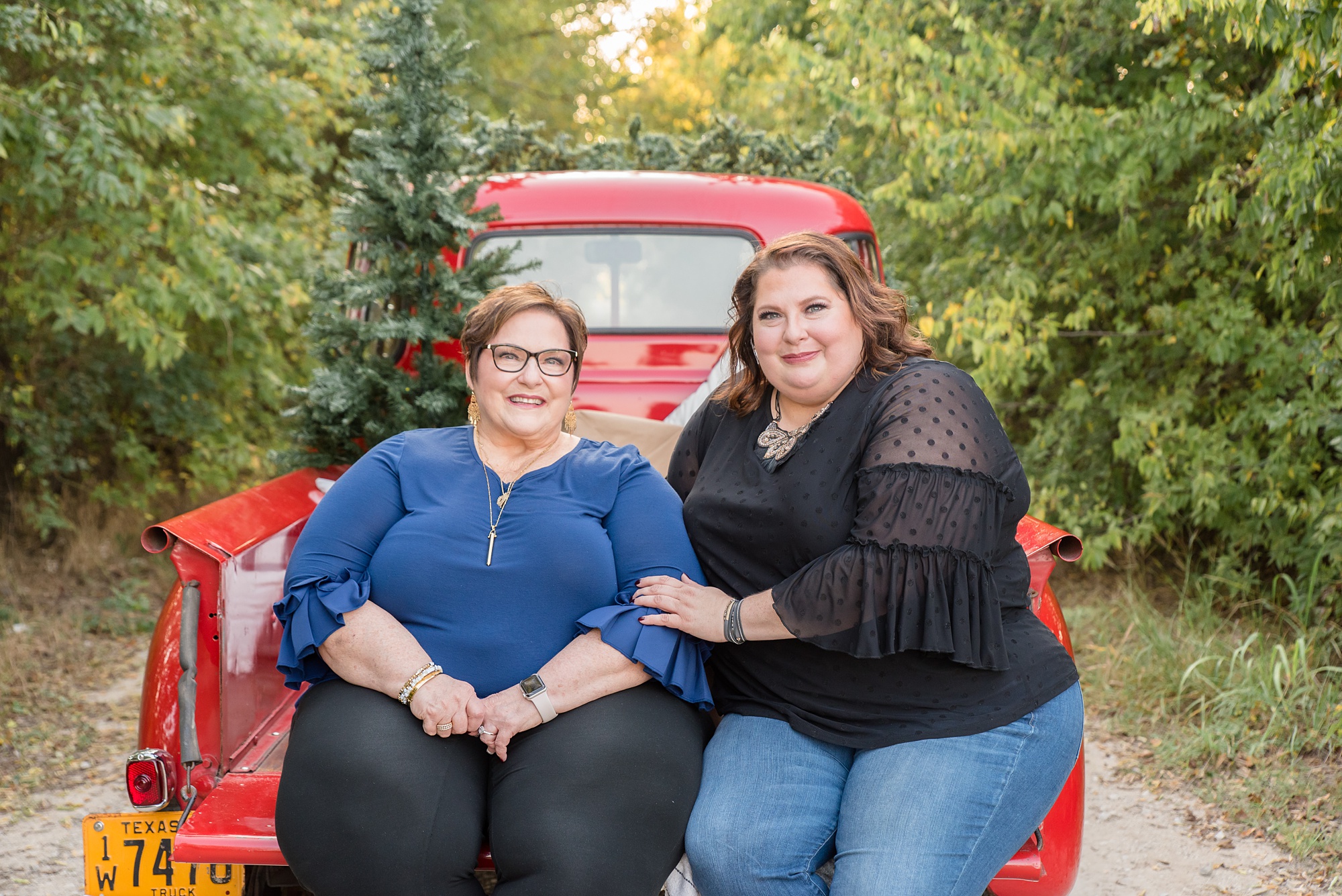 mom and daughter pose for Red Truck Christmas minis