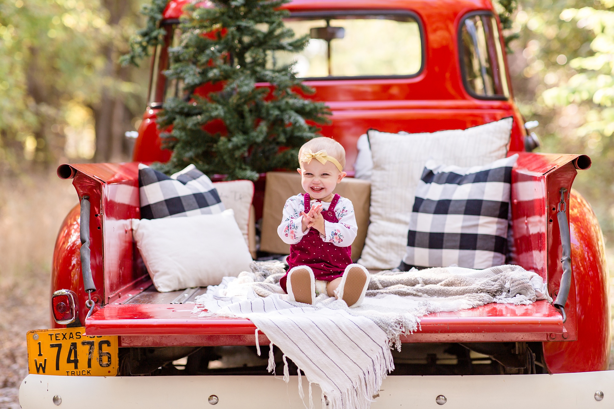 toddler claps in back of vintage red truck