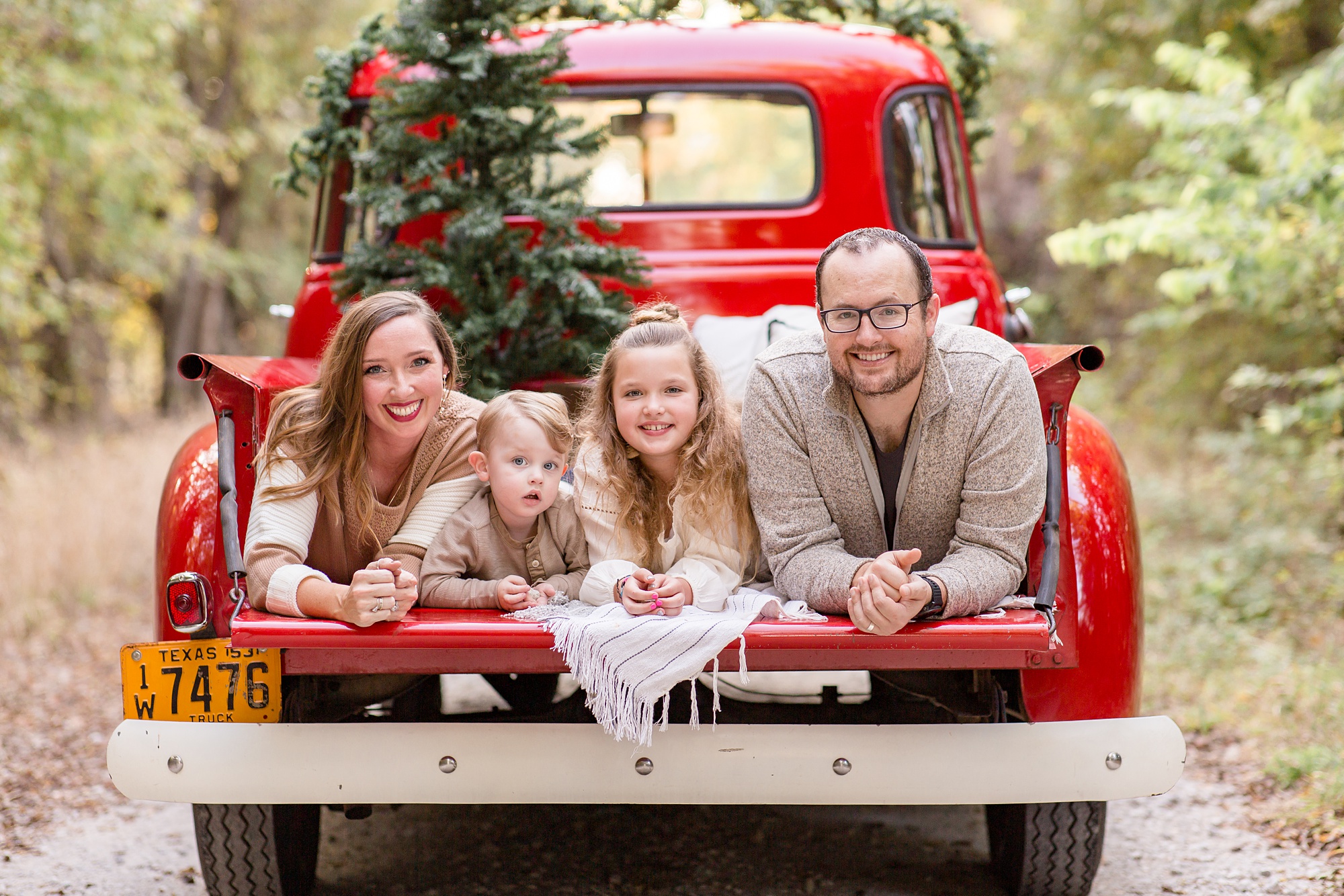 family lays in truck bed during TX holiday photos