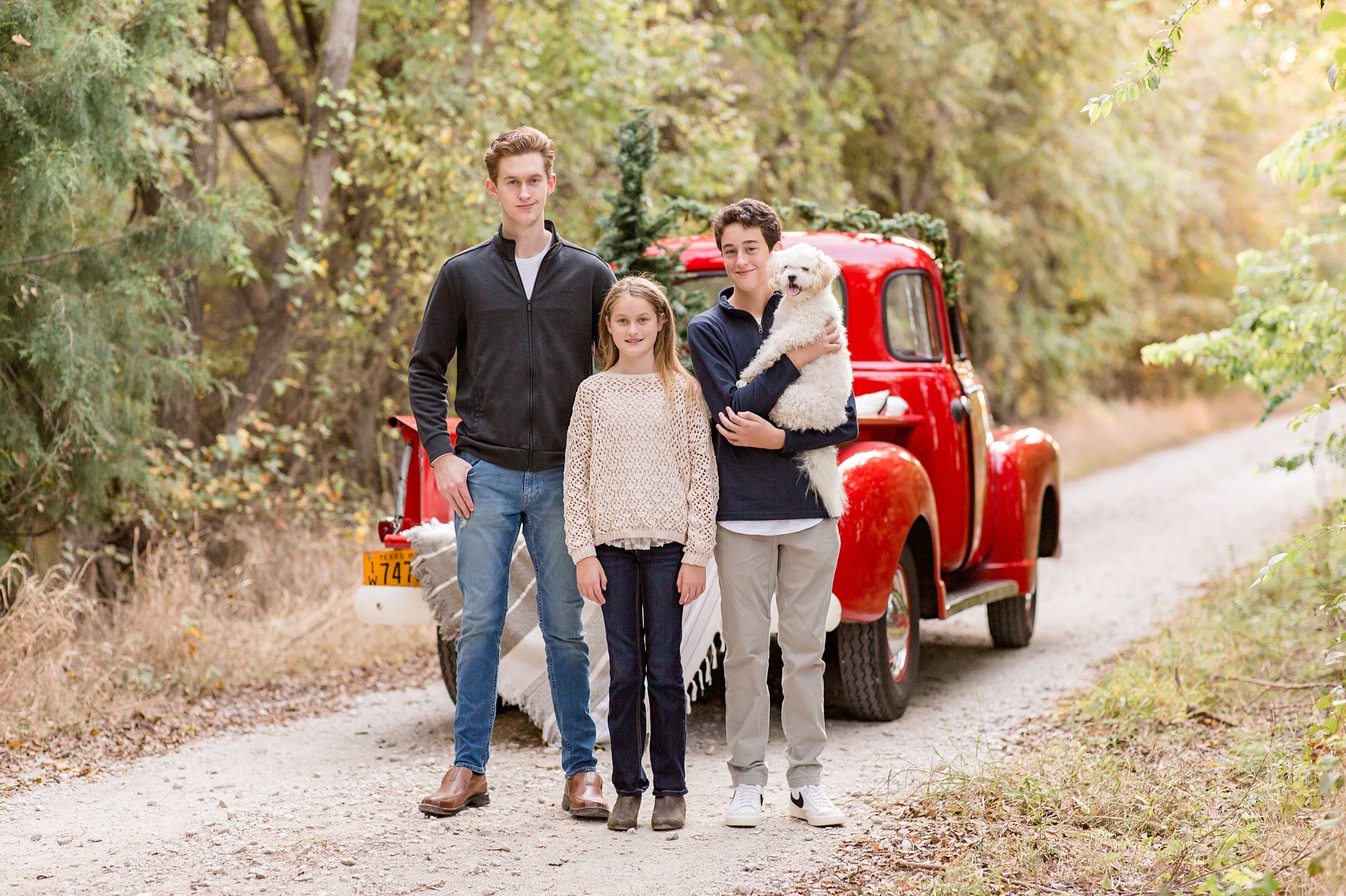 siblings stand by red truck with dog during McKinney TX mini sessions