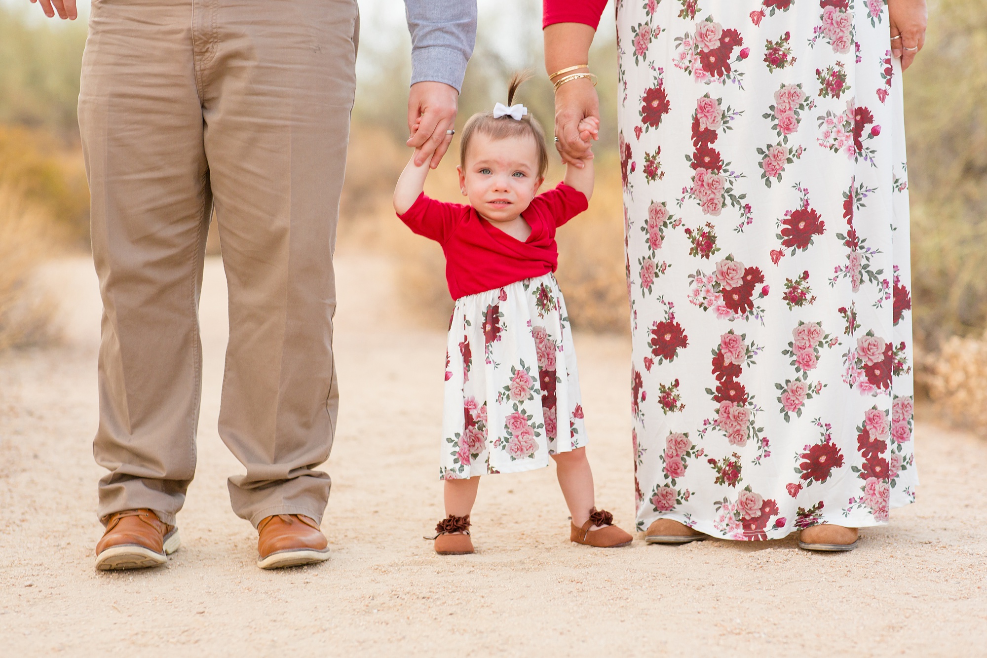 toddler stands between parents during Usery Park mini sessions