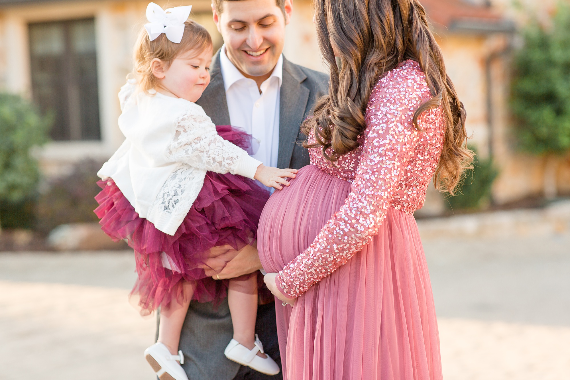 toddler touches mom's stomach during Texas maternity photos